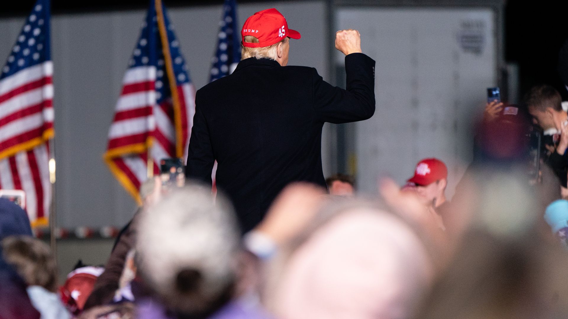 Former President Trump is seen pumping a fist to the crowd after a speech in Georgia on Saturday.