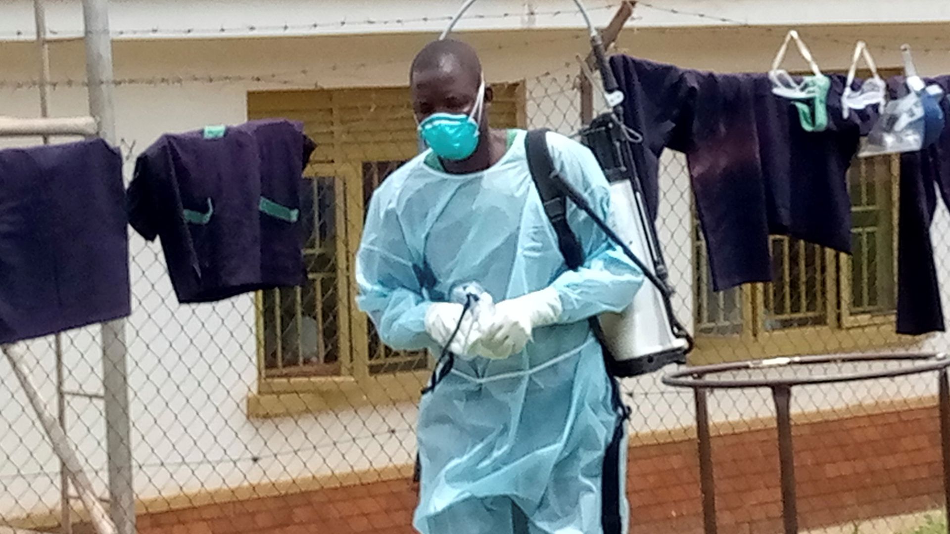 A medical worker is seen after disinfecting a demarcated Ebola treatment center at the Mubende Regional Hospital in Mubende District, Uganda.