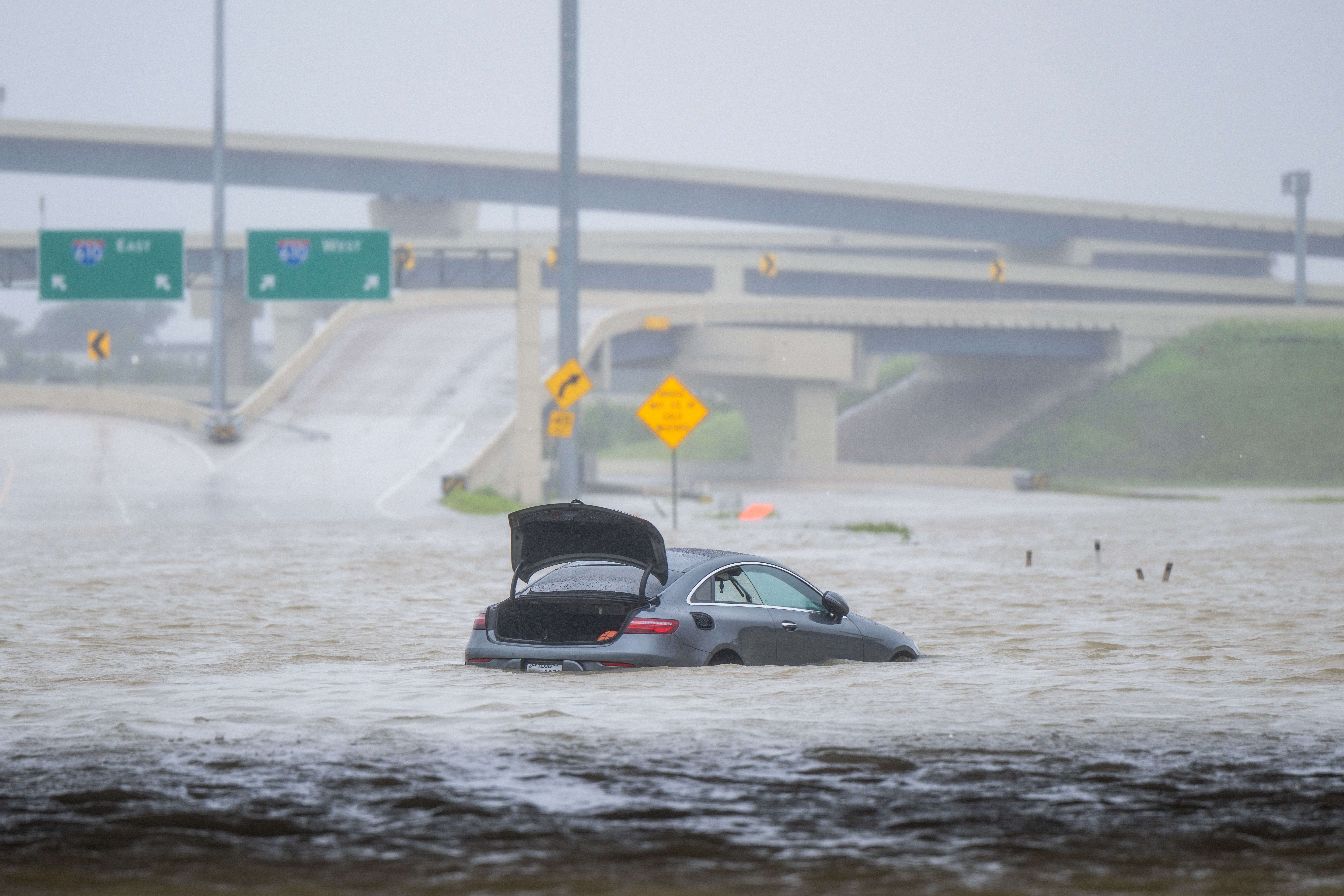 HOUSTON, TEXAS - JULY 08: A vehicle is left abandoned in floodwater on a highway after Hurricane Beryl swept through the area on July 08, 2024 in Houston, Texas. Tropical Storm Beryl developed into a Category 1 hurricane as it hit the Texas coast late last night. (Photo by Brandon Bell/Getty Images)