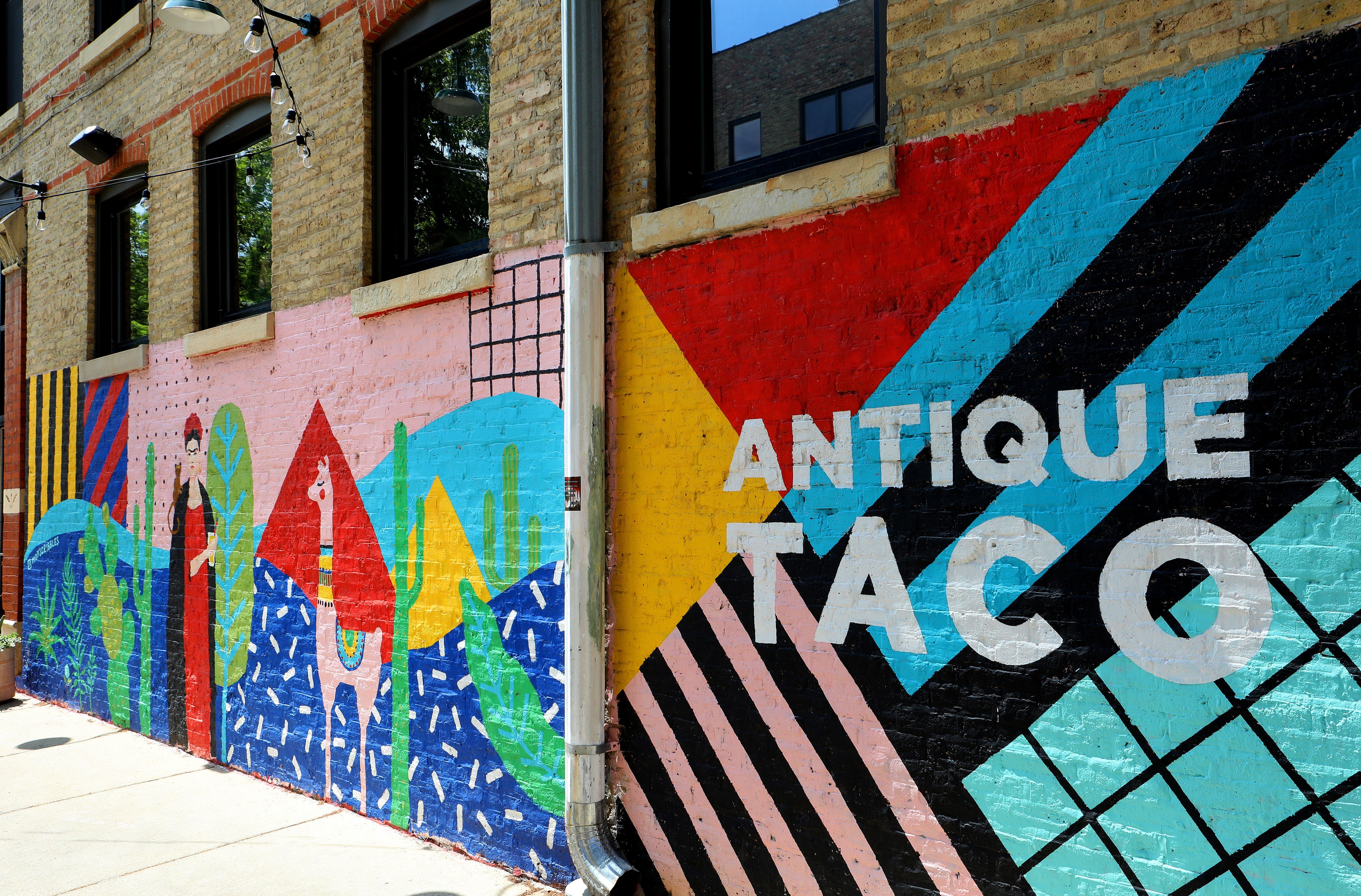 Photo of a mural that says "Antique Taco" 
