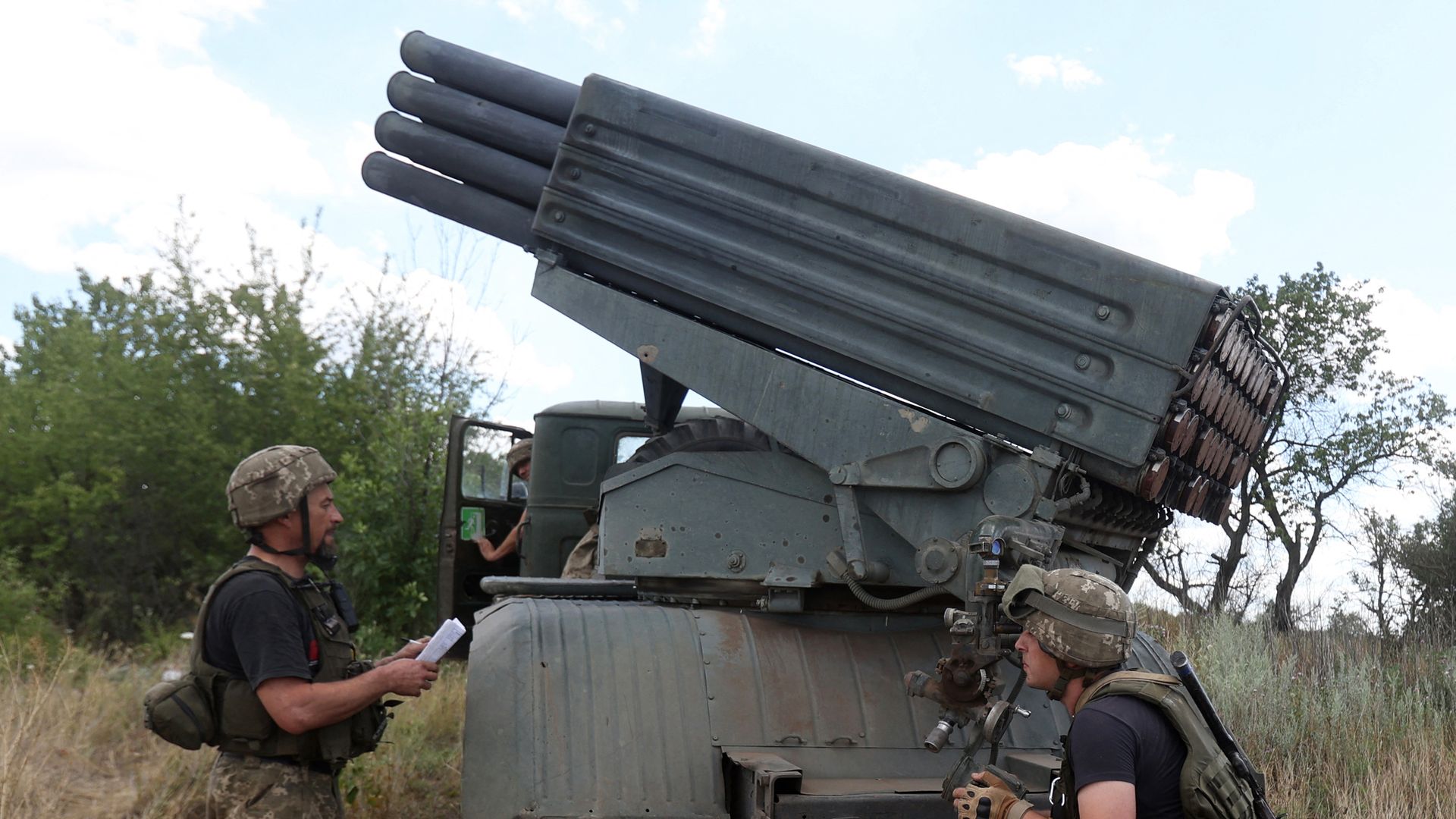Ukrainian servicemen prepare to fire a Grad BM-21 multiple rocket launcher