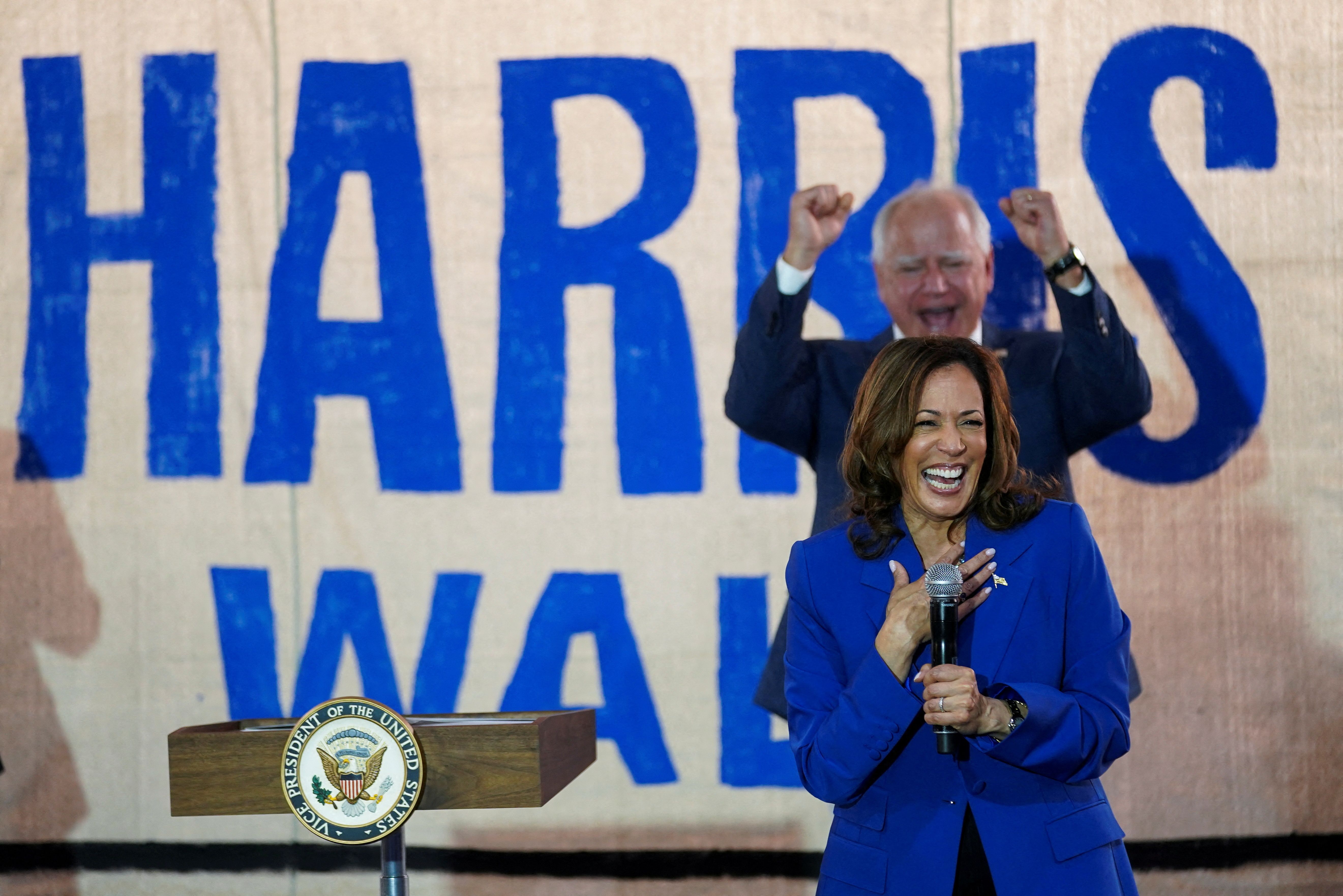 V.P. nominee Tim Walz cheers Vice President Kamala Harris at a campaign field office yesterday in Rochester, Pa.
