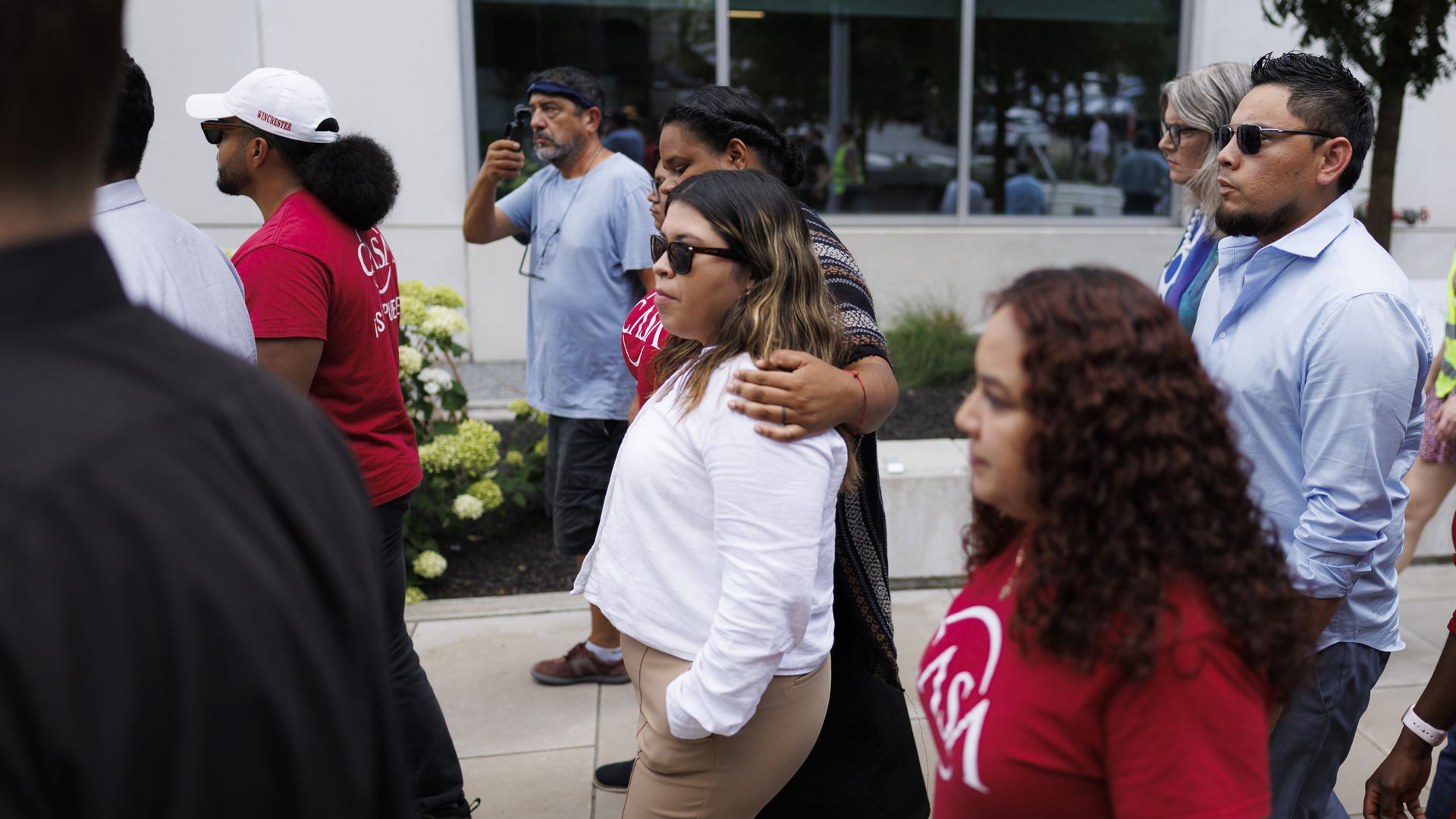 Woman in white center with others around her
