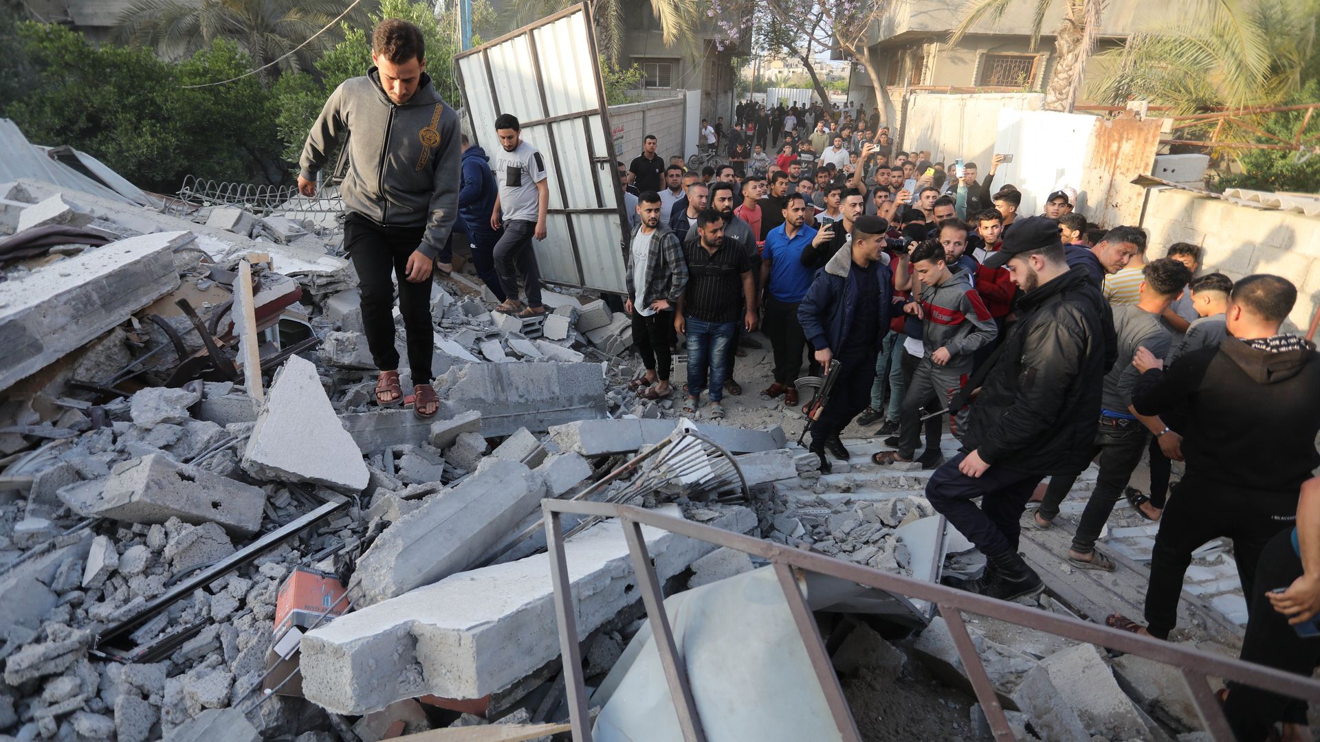 Palestinians inspect a building destroyed Israeli strikes on May 13 in Gaza City. Photo:  Ashraf Amra/Anadolu Agency via Getty Images