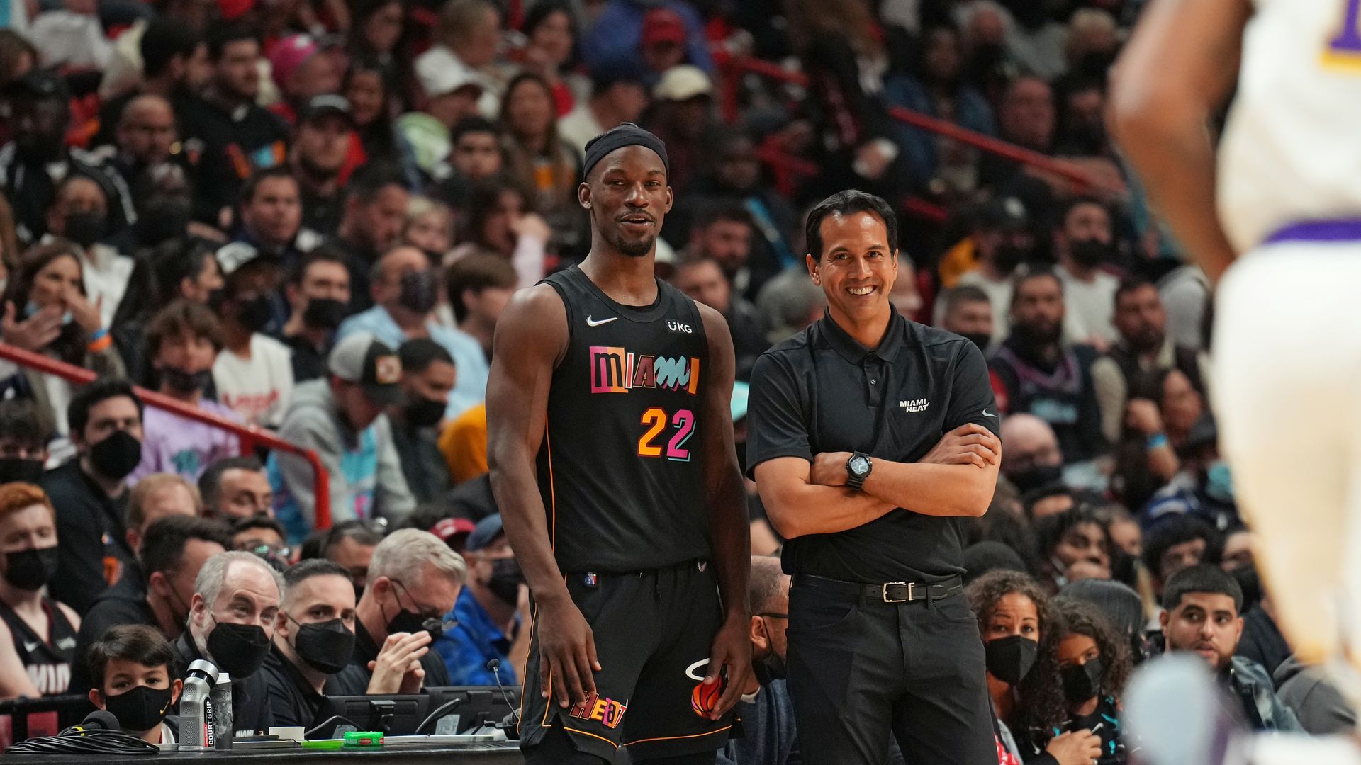 Heat coach Erik Spoelstra and Jimmy Butler stand together during a game.