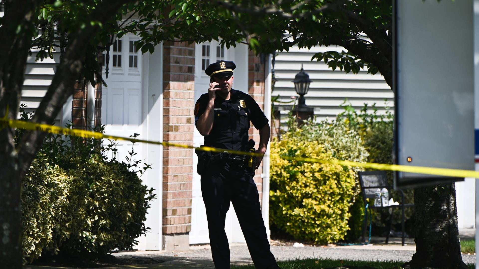 A police officer outside of a home in Farmingville, New York, in July 2021.