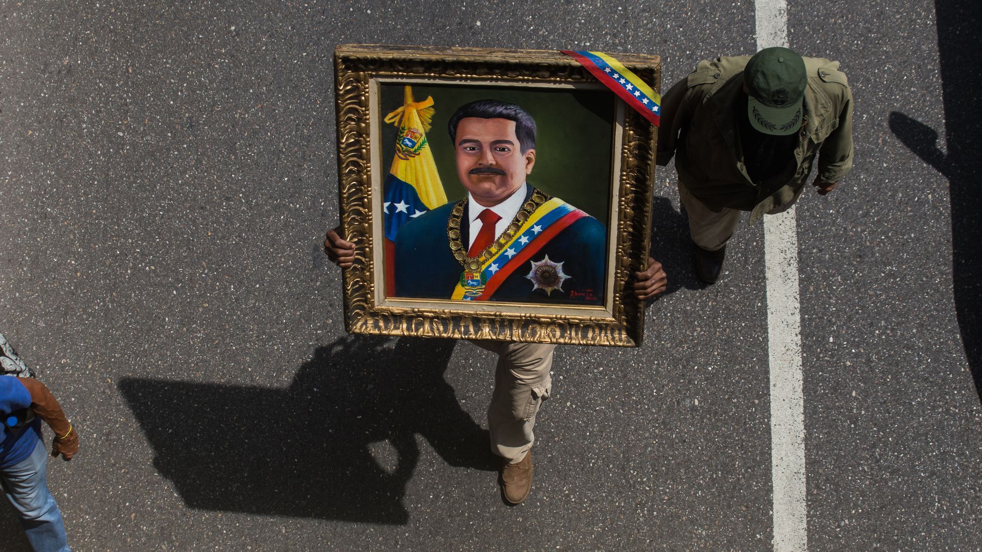 Photo of someone carrying President Maduro's portrait on the streets of Venezuela
