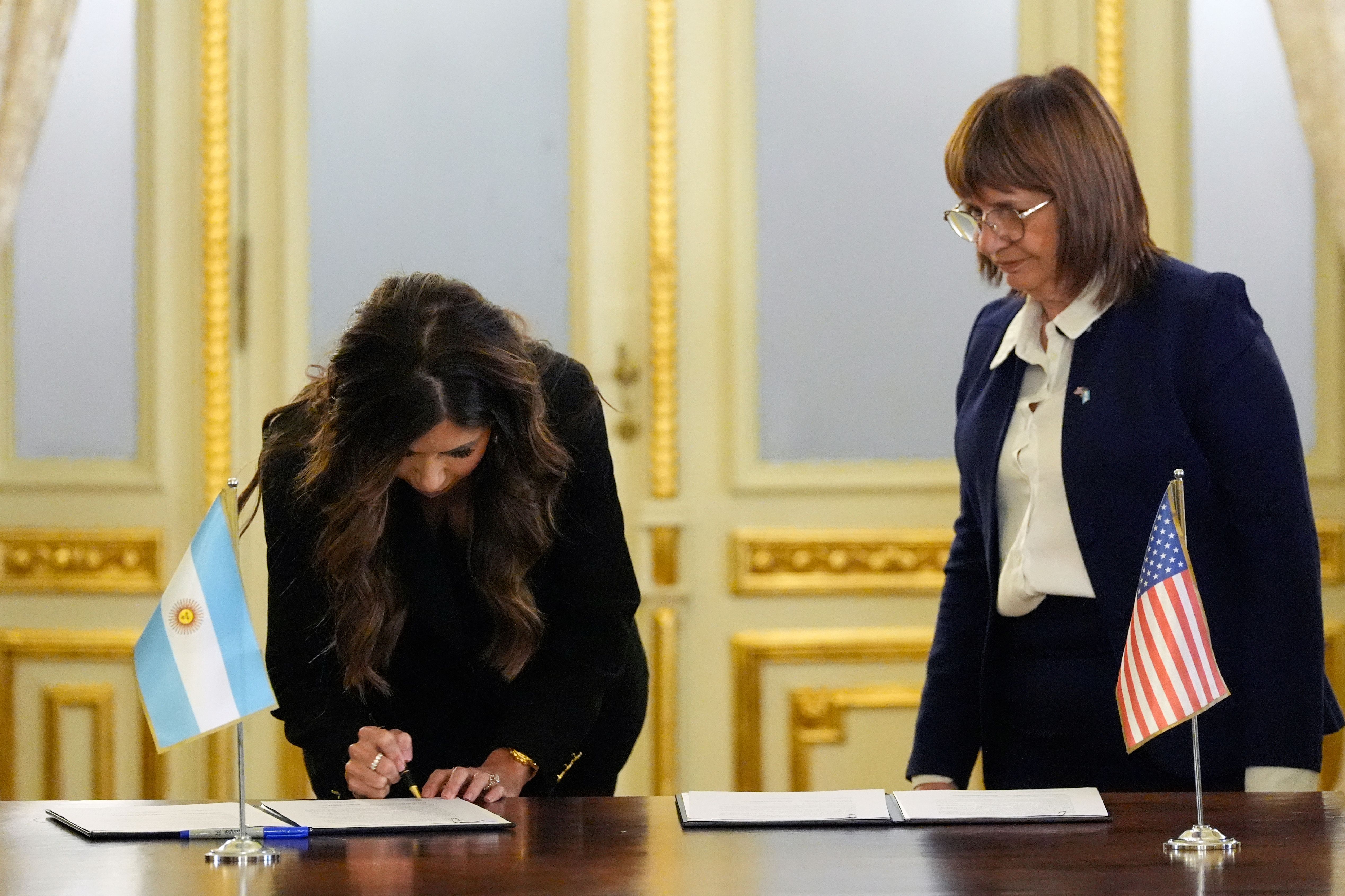 Homeland Security Secretary Kristi Noem signs an agreement with Argentine Security Minister Patricia Bullrich during her visit to the country in July.