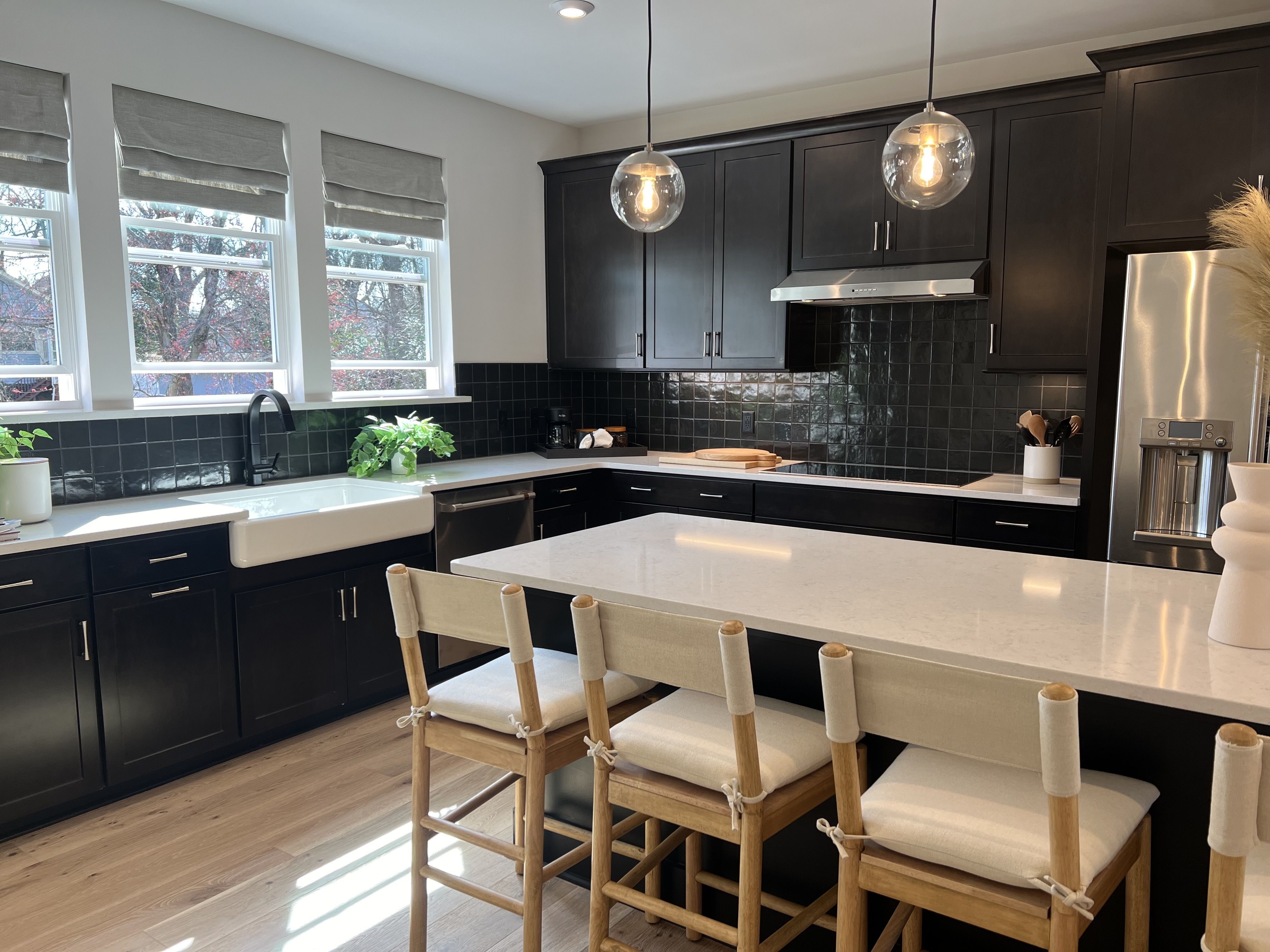 kitchen with black tiles and cabinets