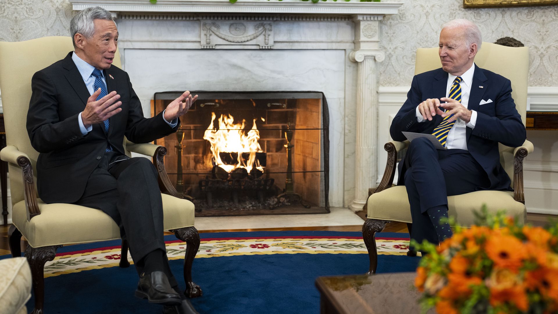 Sinapore's prime minister is seen sitting with President Biden in the Oval Office.