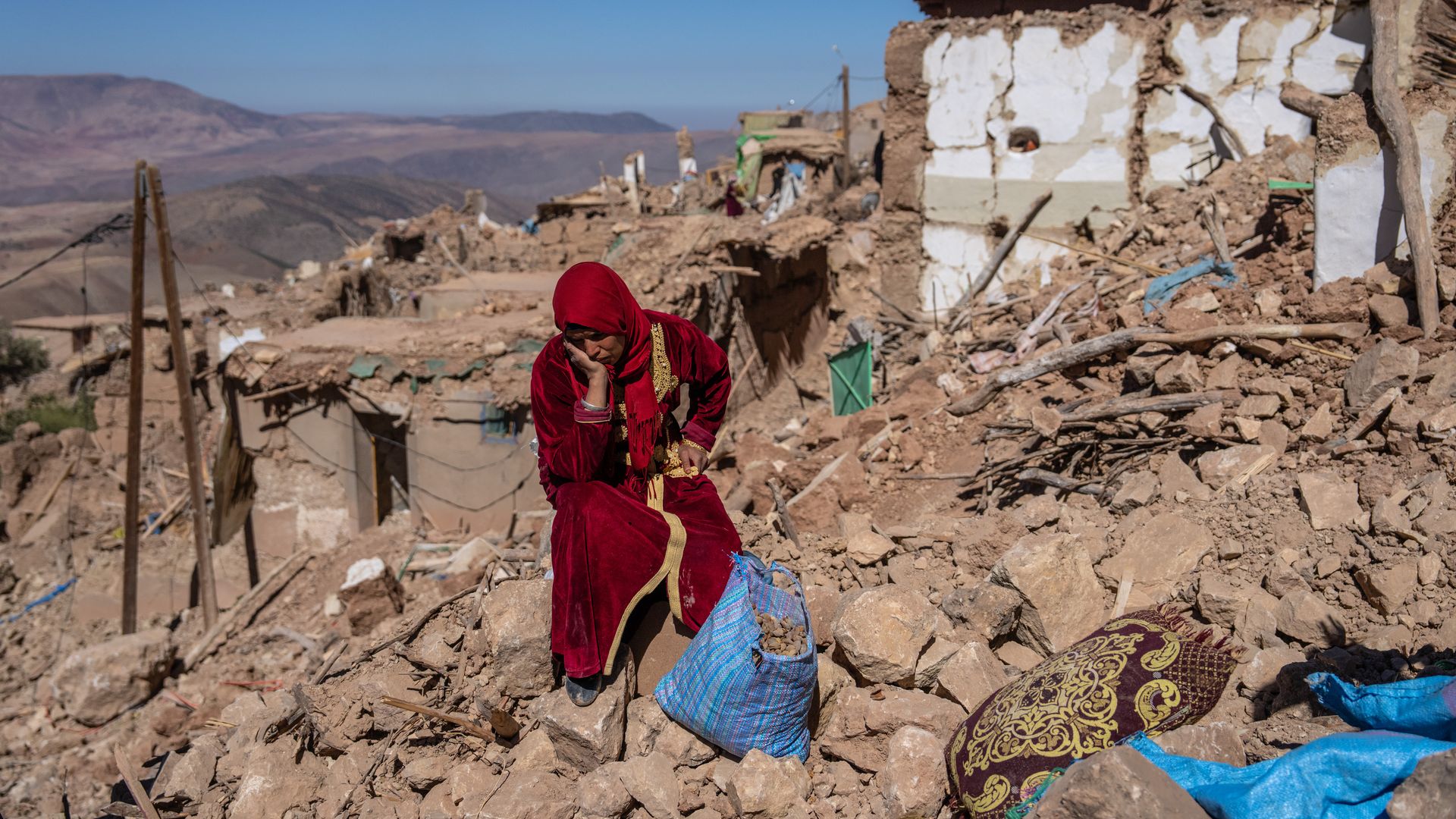  A woman sits amongst the rubble of her village that was almost completely destroyed by Friday's earthquake, on September 11, 2023 in Douzrou, Morocco
