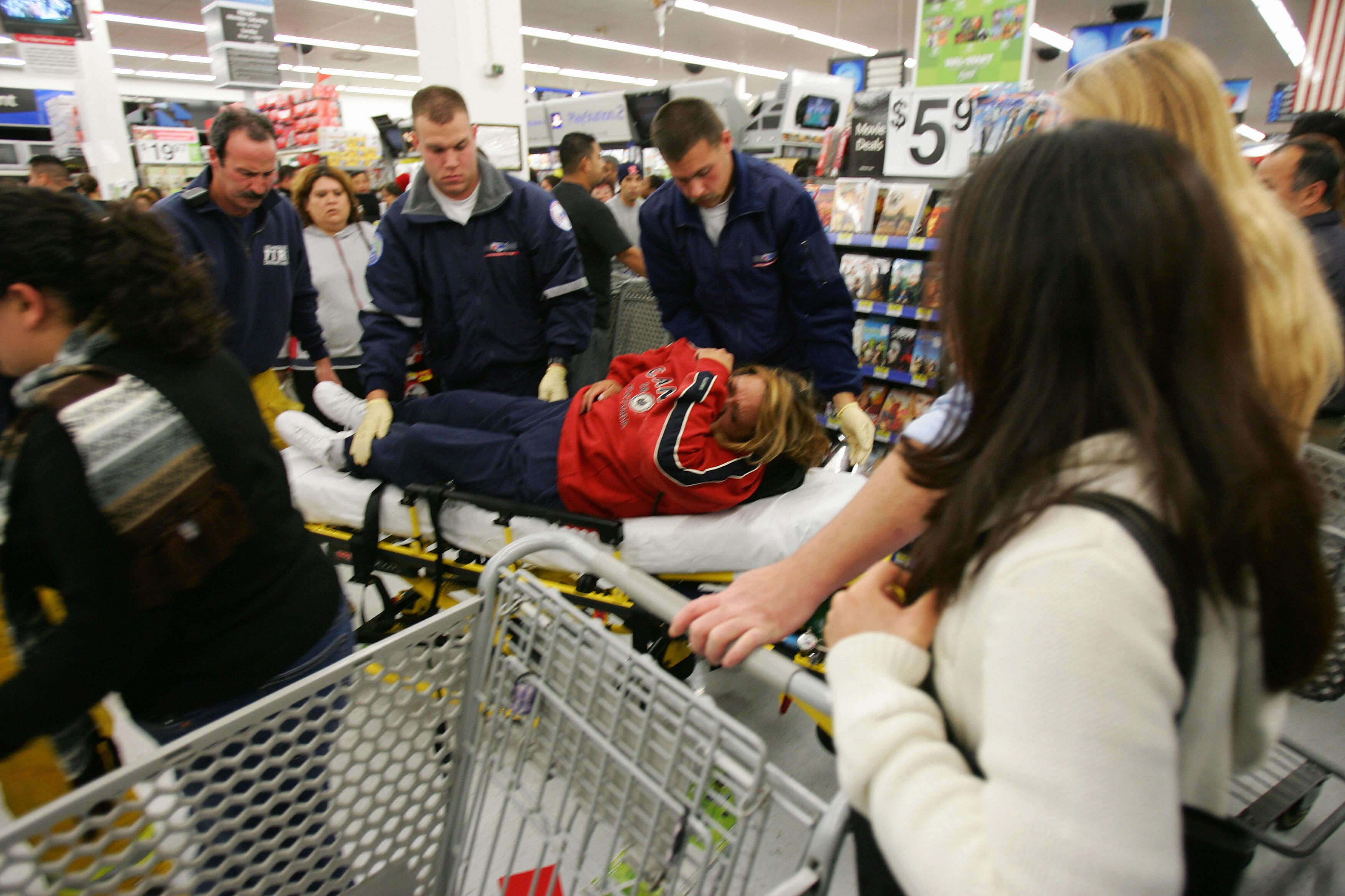 A customer on a gurney in a store on Black Friday. 