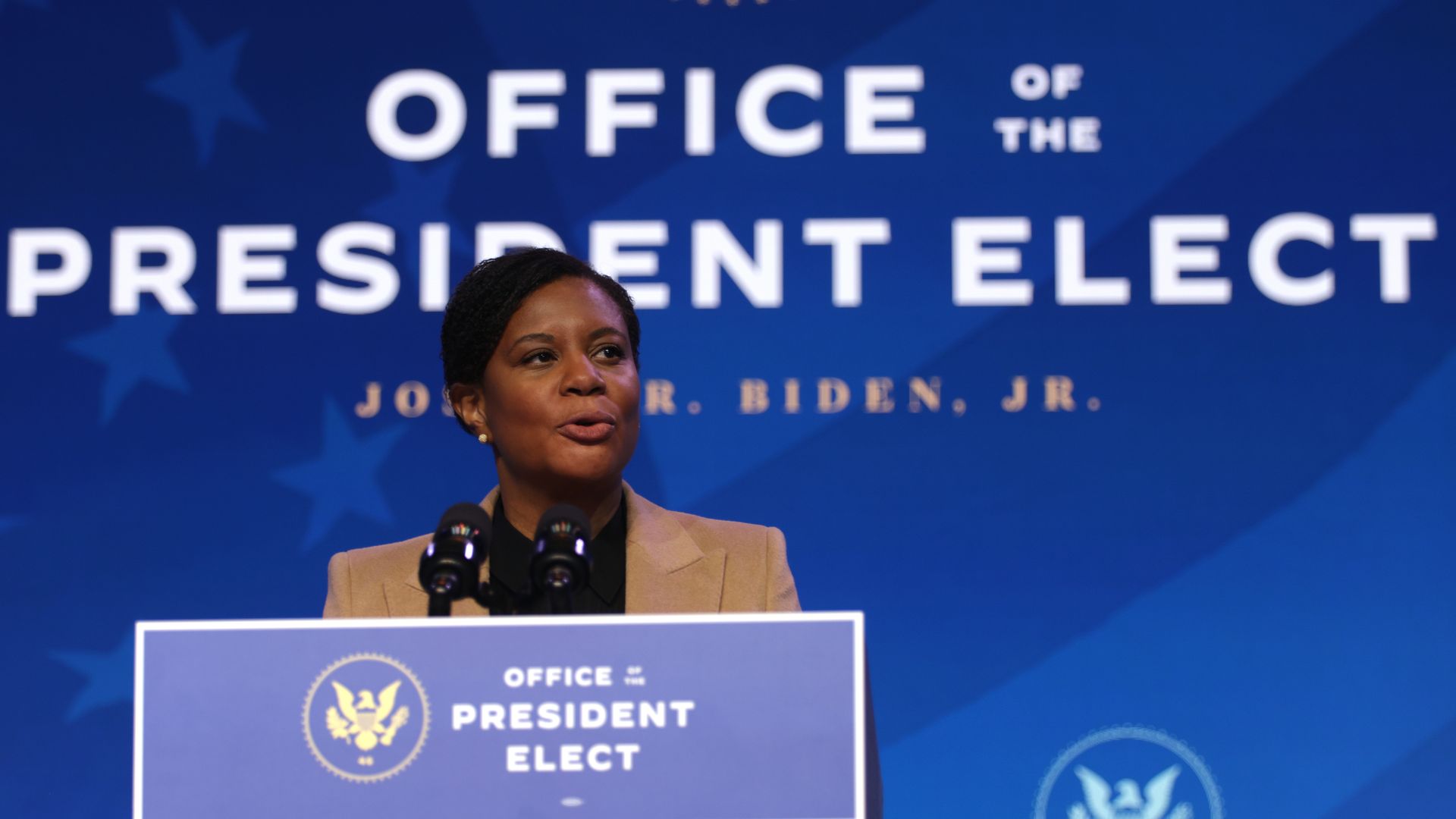 Alondra Nelson speaks at a podium at an event in Delaware with President Biden
