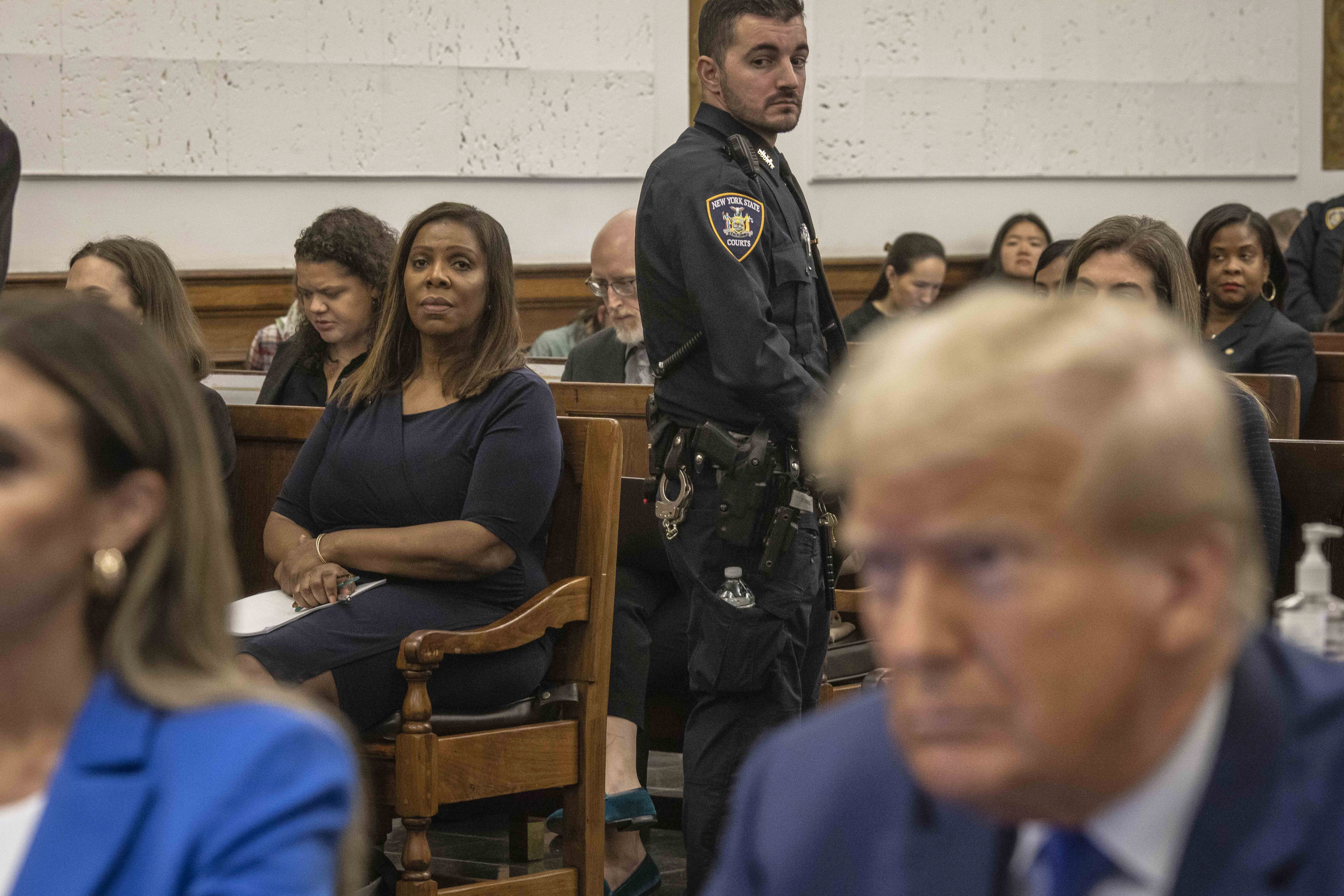 New York Attorney General Letitia James sits in a courtroom near President Trump during his civil fraud trial in 2023.
