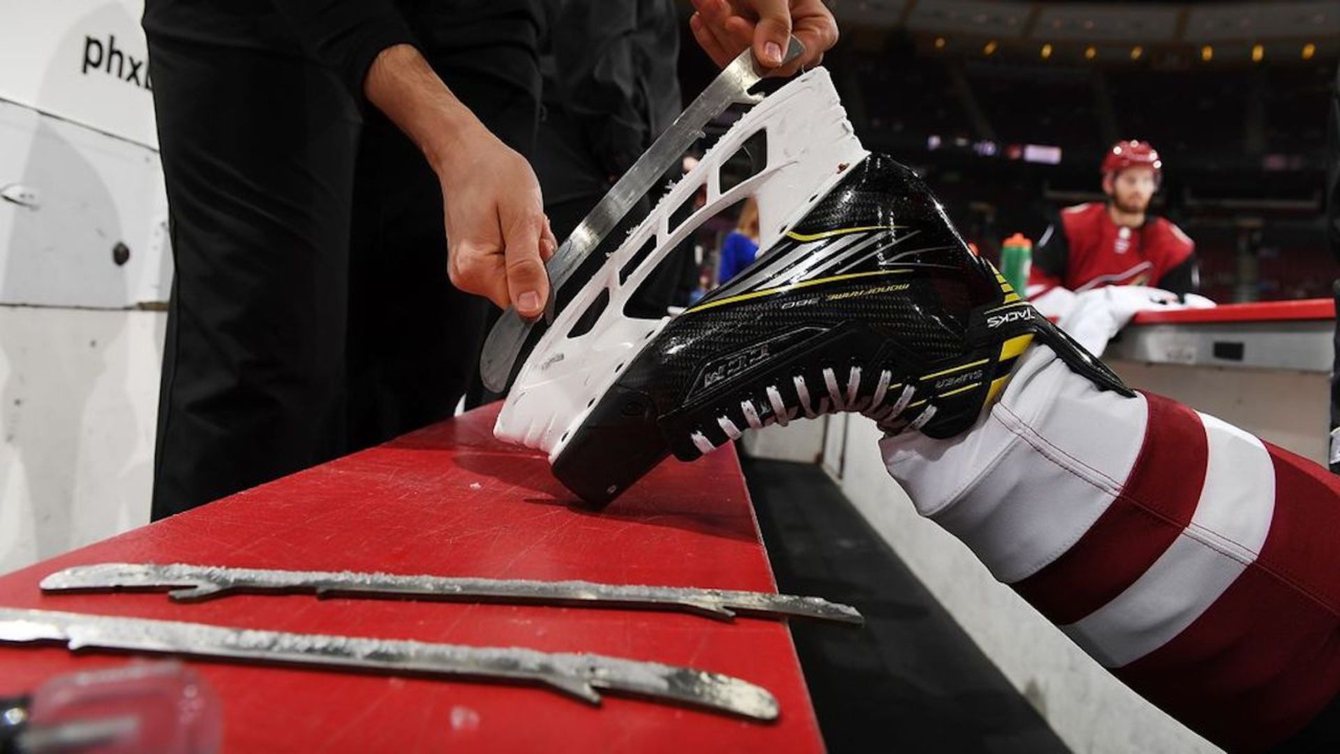 Someone sharpening a hockey blade