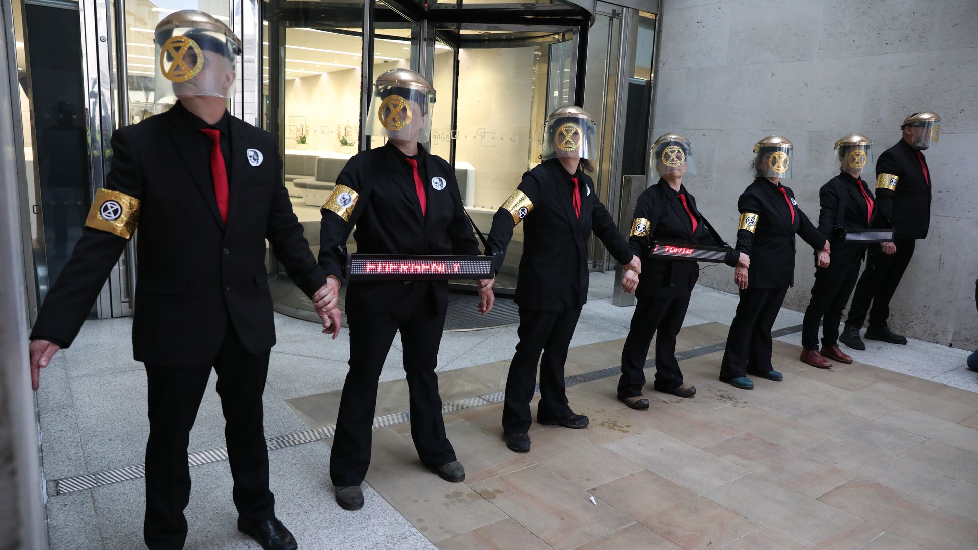  Extinction Rebellion protesters who have glued themselves to the entrances of the London Stock Exchange.