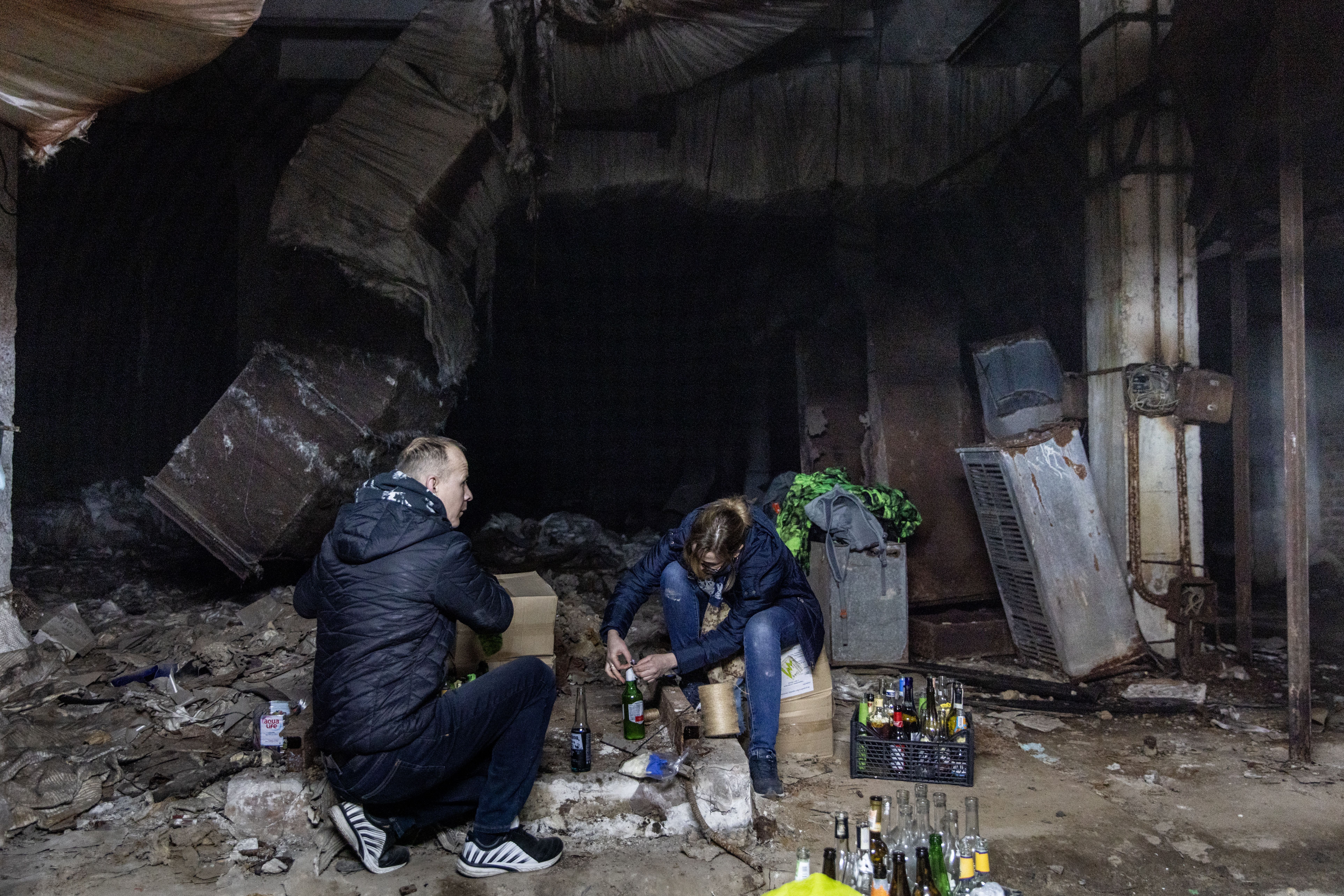 Volunteers work to make molotov cocktails in the basement of a bomb shelter on February 26, 2022 in Kyiv.