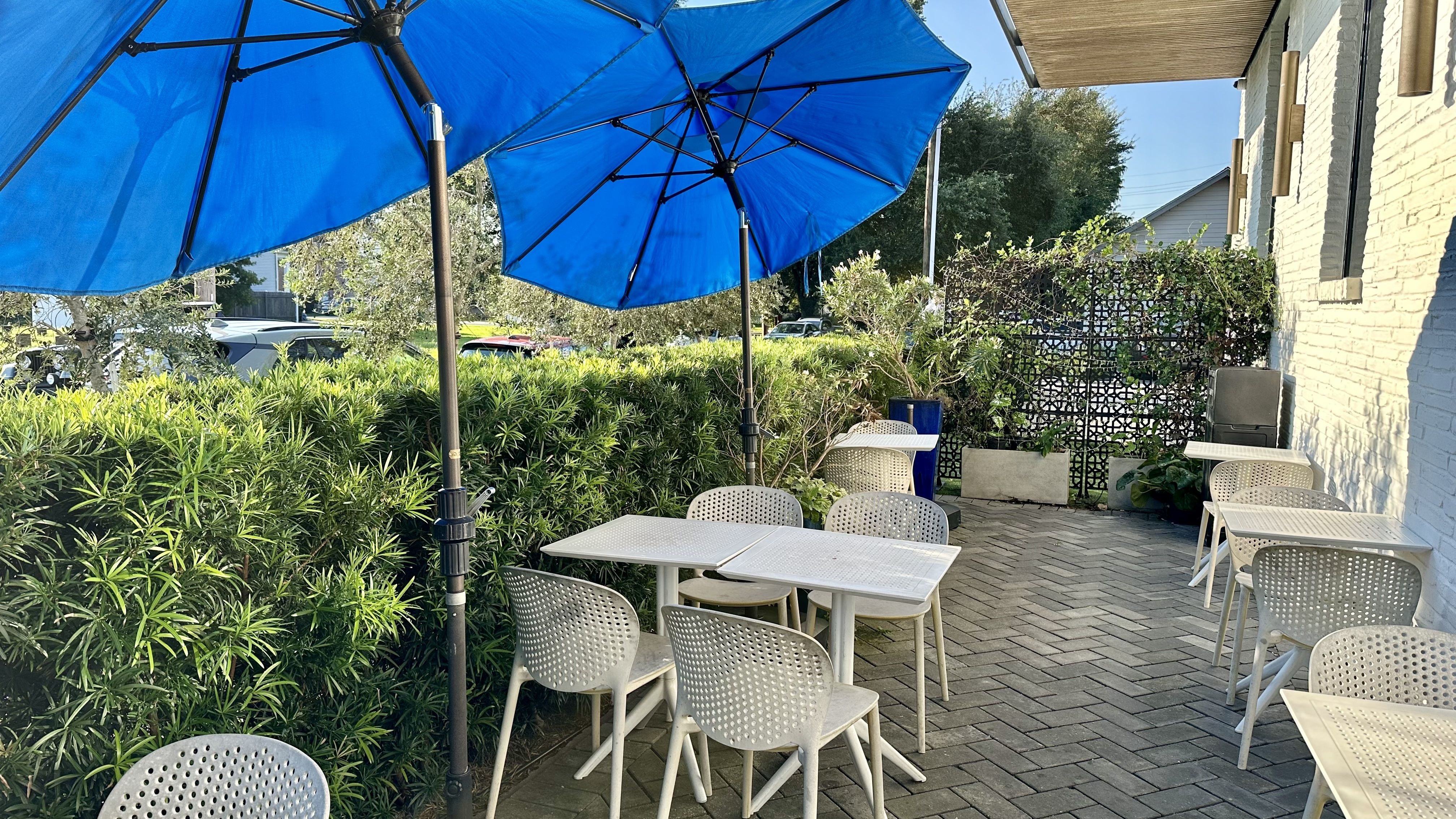 Image shows the patio at Celtica with blue umbrellas.