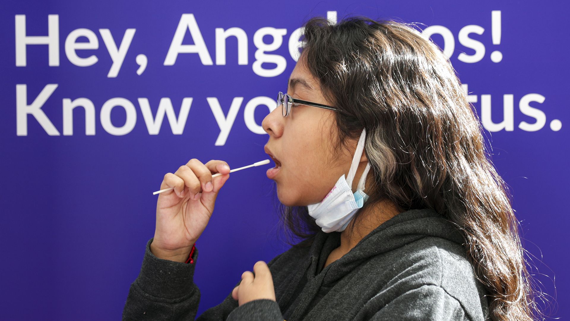 Laura Robles, 14, left, takes a self-administered oral swab COVID-19 test at Union Station site on Wednesday, Nov. 11, 2020 in Los Angeles