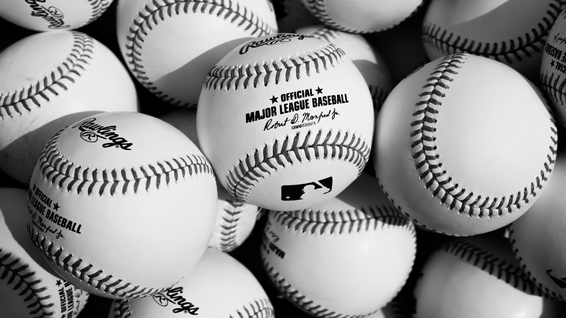 White baseballs that read "official Major League Baseball" with the commissioner's signature. 
