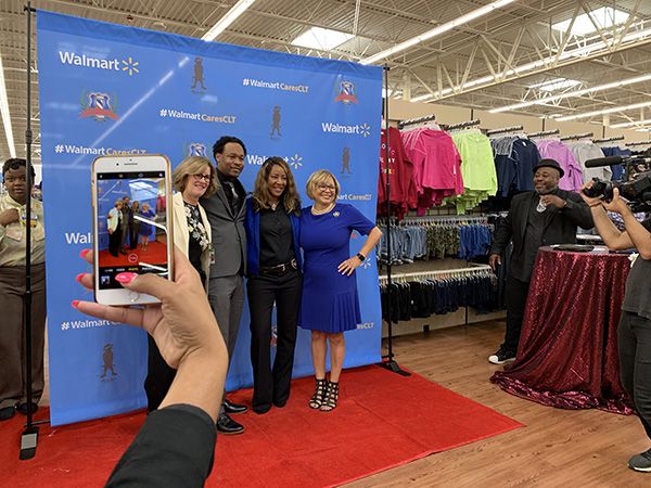 Lucky Corbett, grand opening, in front of Walmart sign