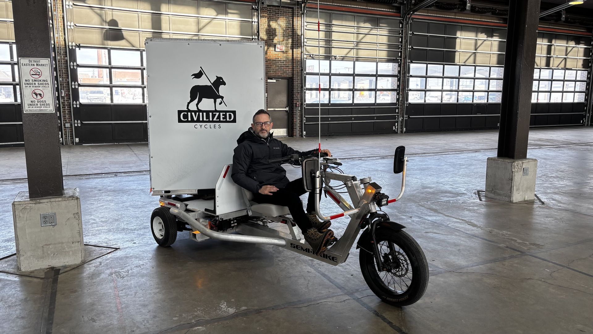 Civilized Cycles co-founder Zachary Schieffelin on one of the company's semi-trikes at Eastern Market. 