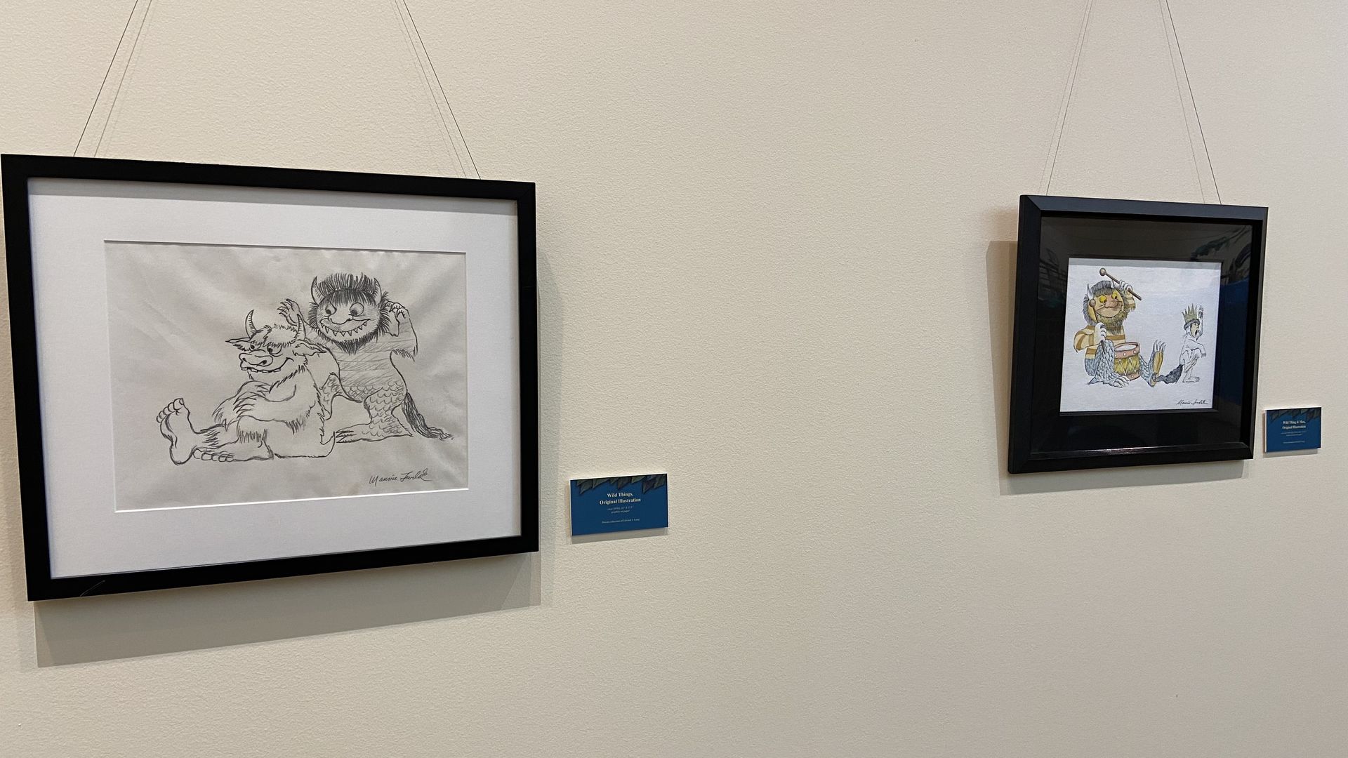Maurice Sendak sketches and drawings hang on a wall 