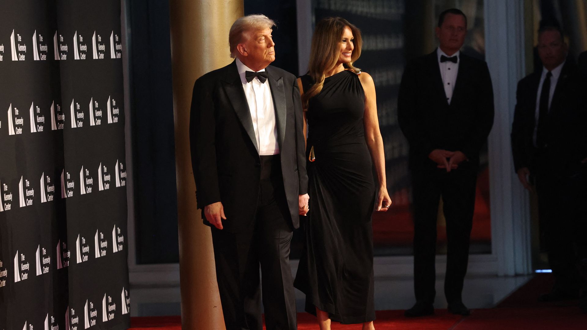 President Donald Trump and First Lady Melania Trump hold hands as they arrive to attend the opening night of "Les Miserables" at the Kennedy Center