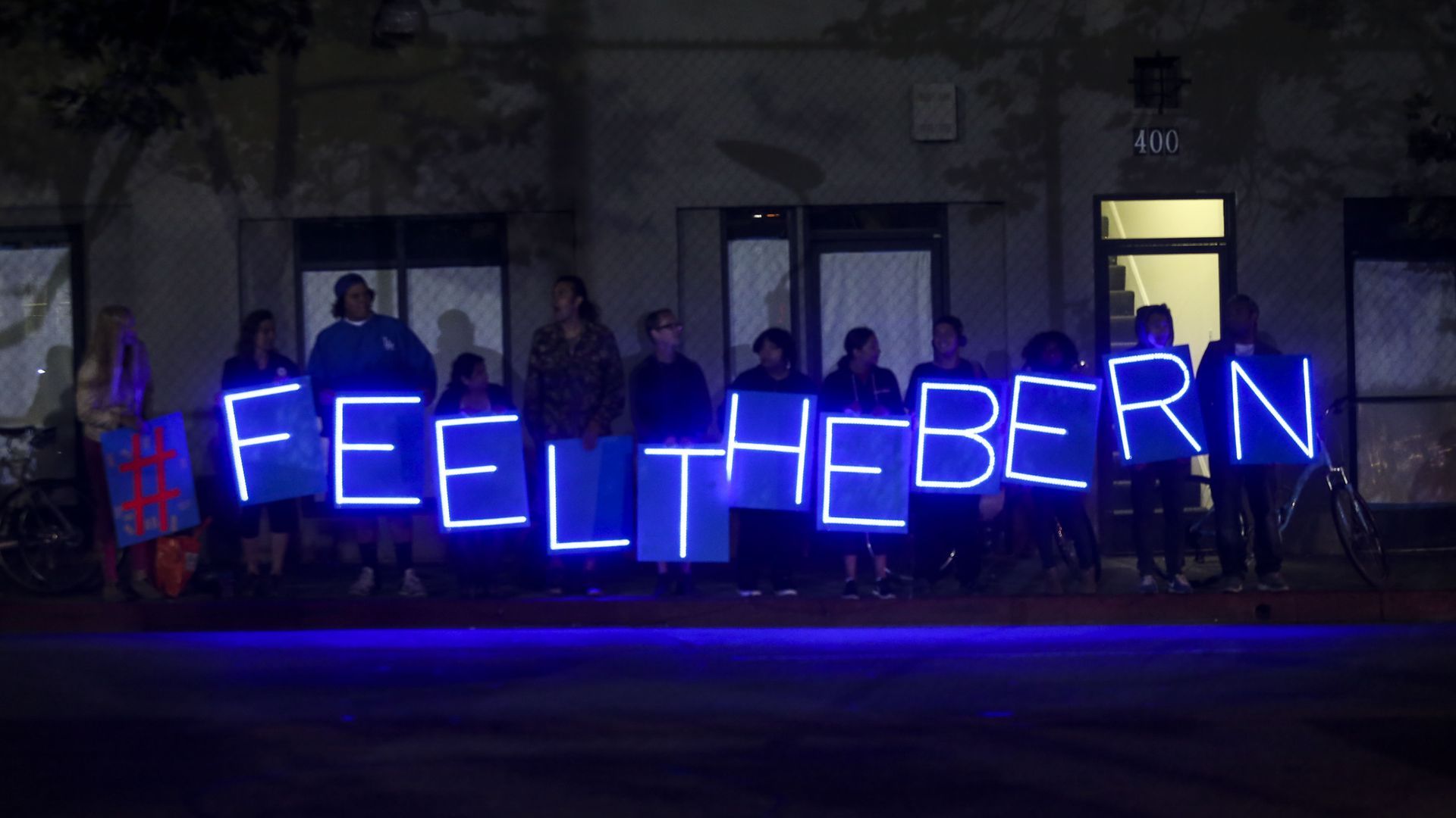 Light up sign people are holding that says #feelthebern