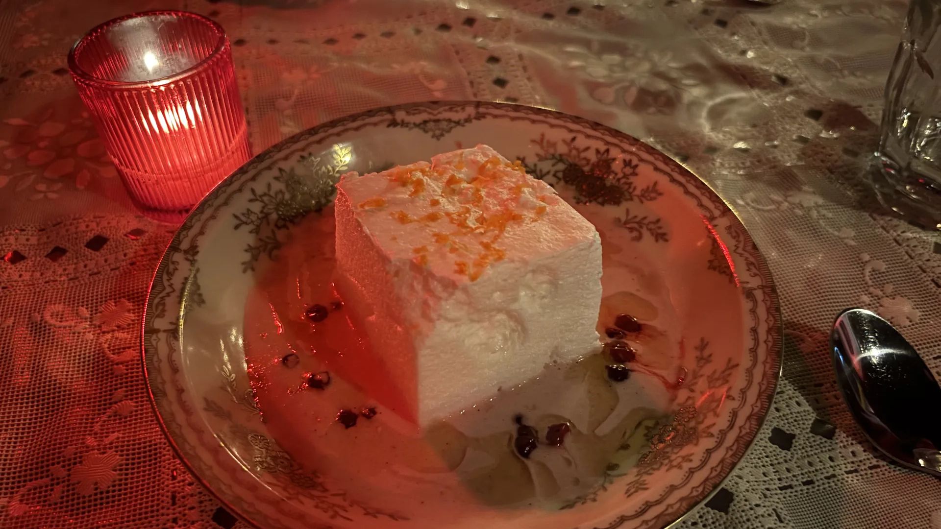 An island of meringue floats in brown butter sauce dotted with lingonberries. Photo: Ryan Deto/Axios