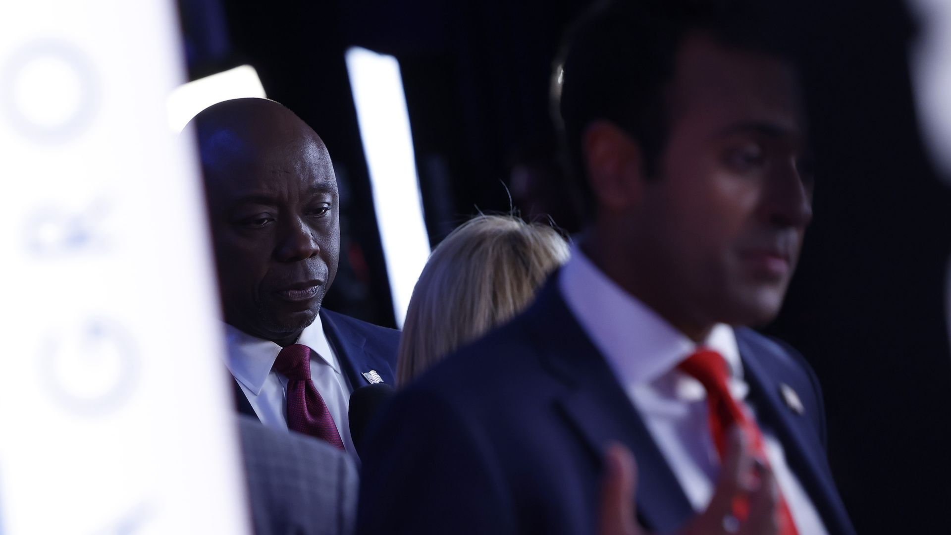 Sen. Tim Scott is shown in the background at left, with Vivek Ramaswamy in the foreground.