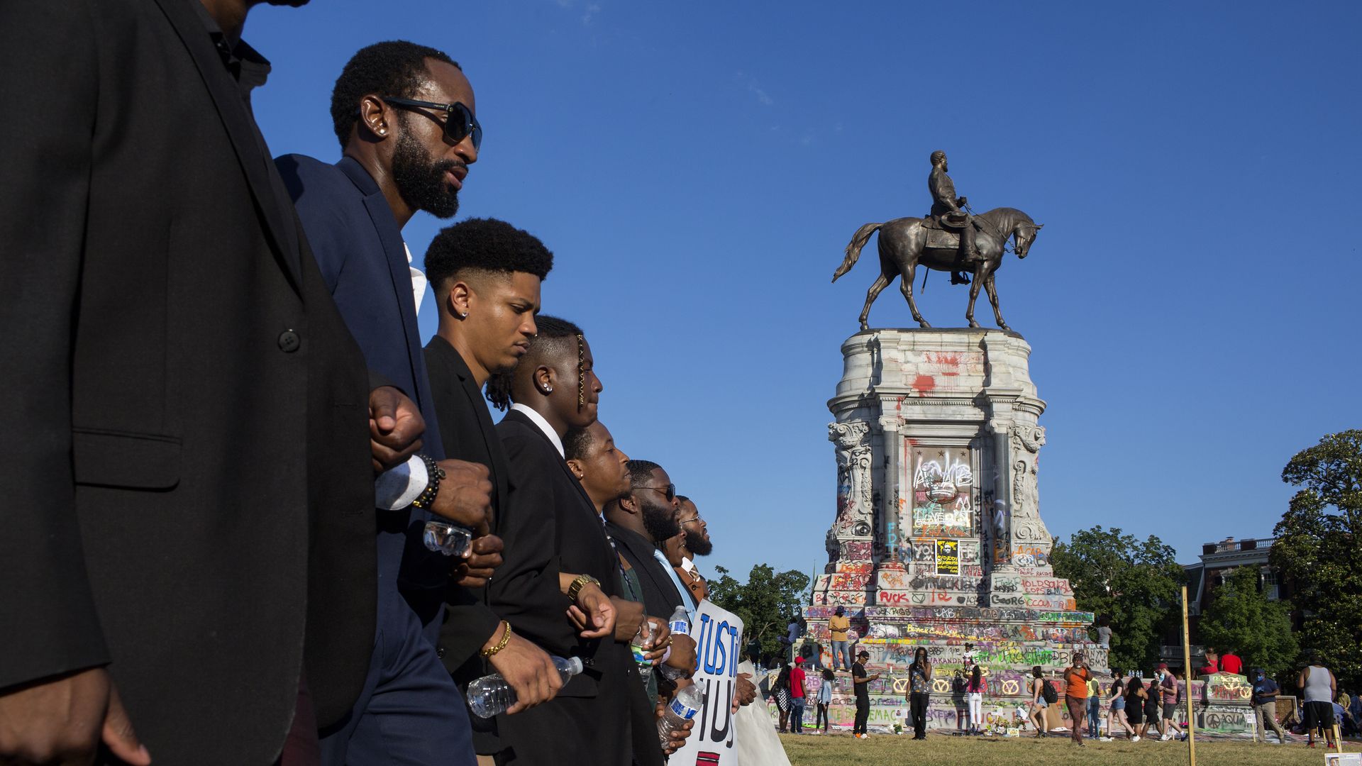 Black Lives Matter activists occupy the traffic circle underneath the statue of Confederate General Robert Lee, now covered in graffiti, on June 13, 2020 at Monument Avenue in Richmond, Virginia.