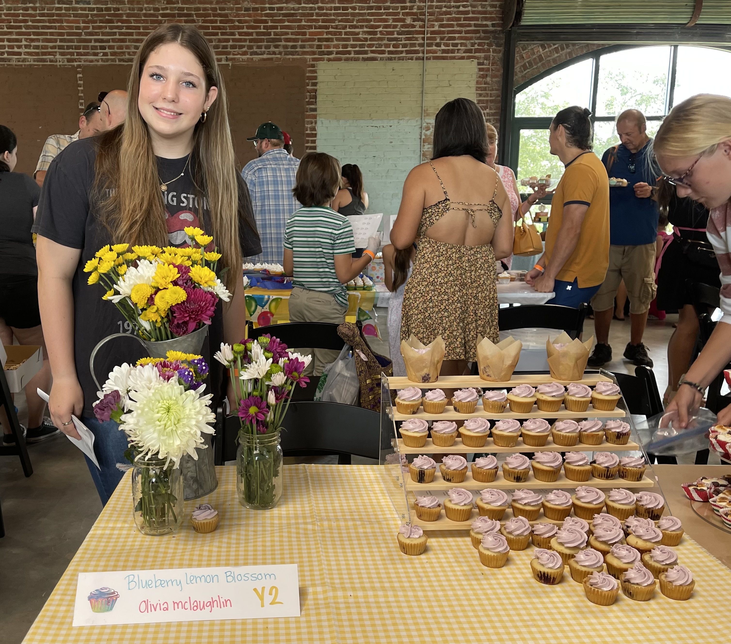 Olivia McLaughlin with her Blueberry Lemon Blossom cupcakes