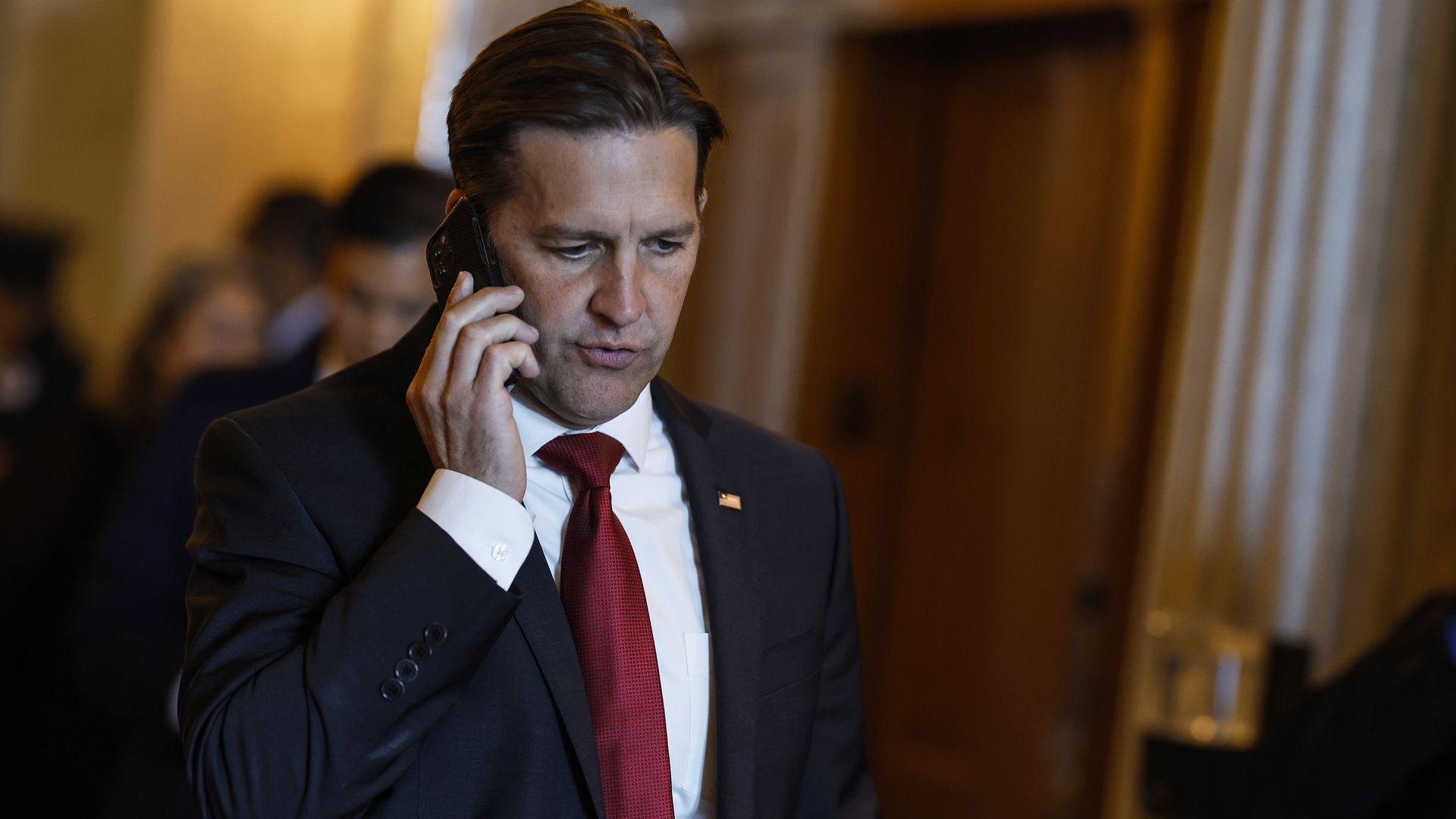 Sen. Ben Sasse (R-NE) speaks on his cell phone as he walks through the U.S. Capitol Building on September 28, 2022 i