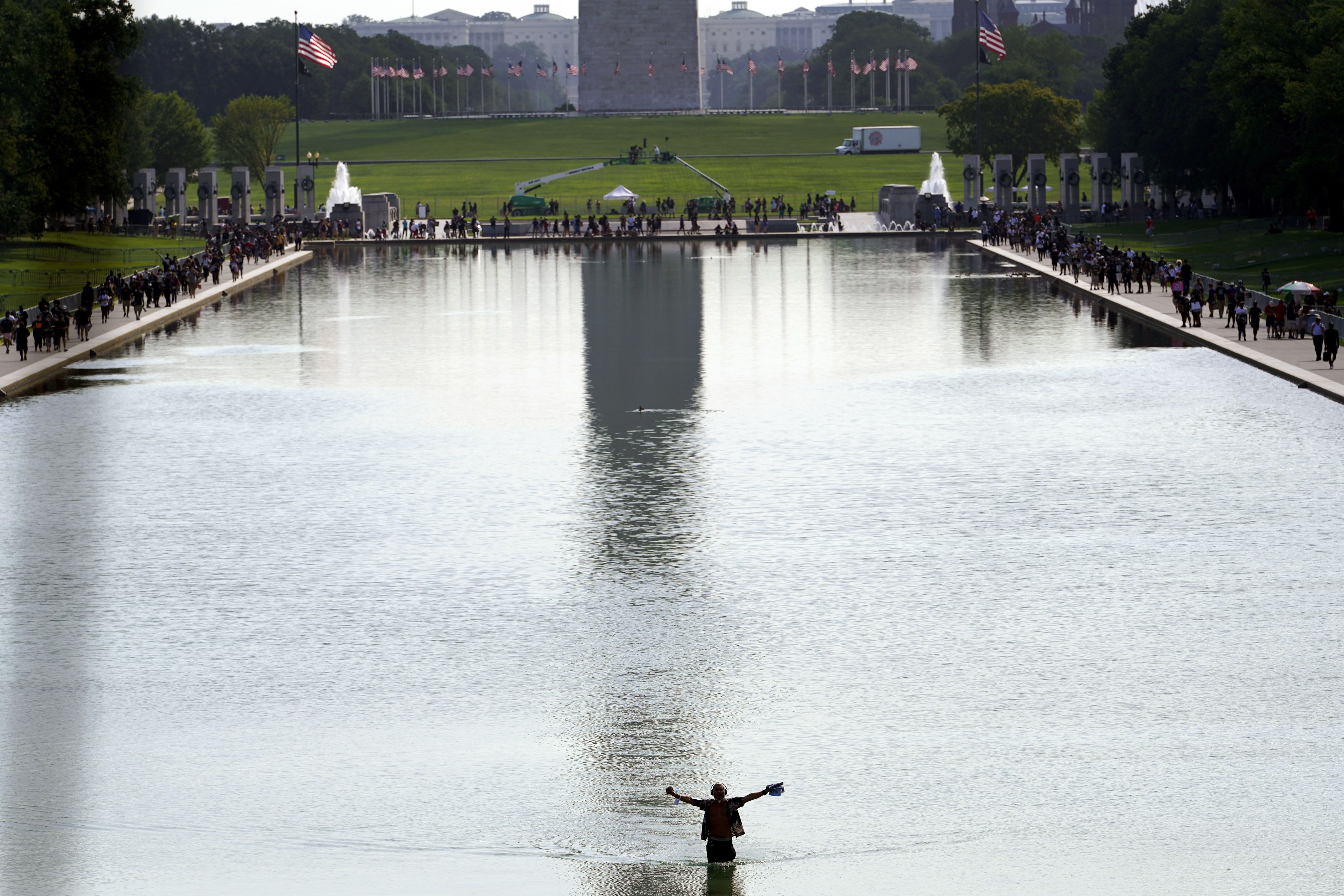 A man walks in the Reflecting Pool