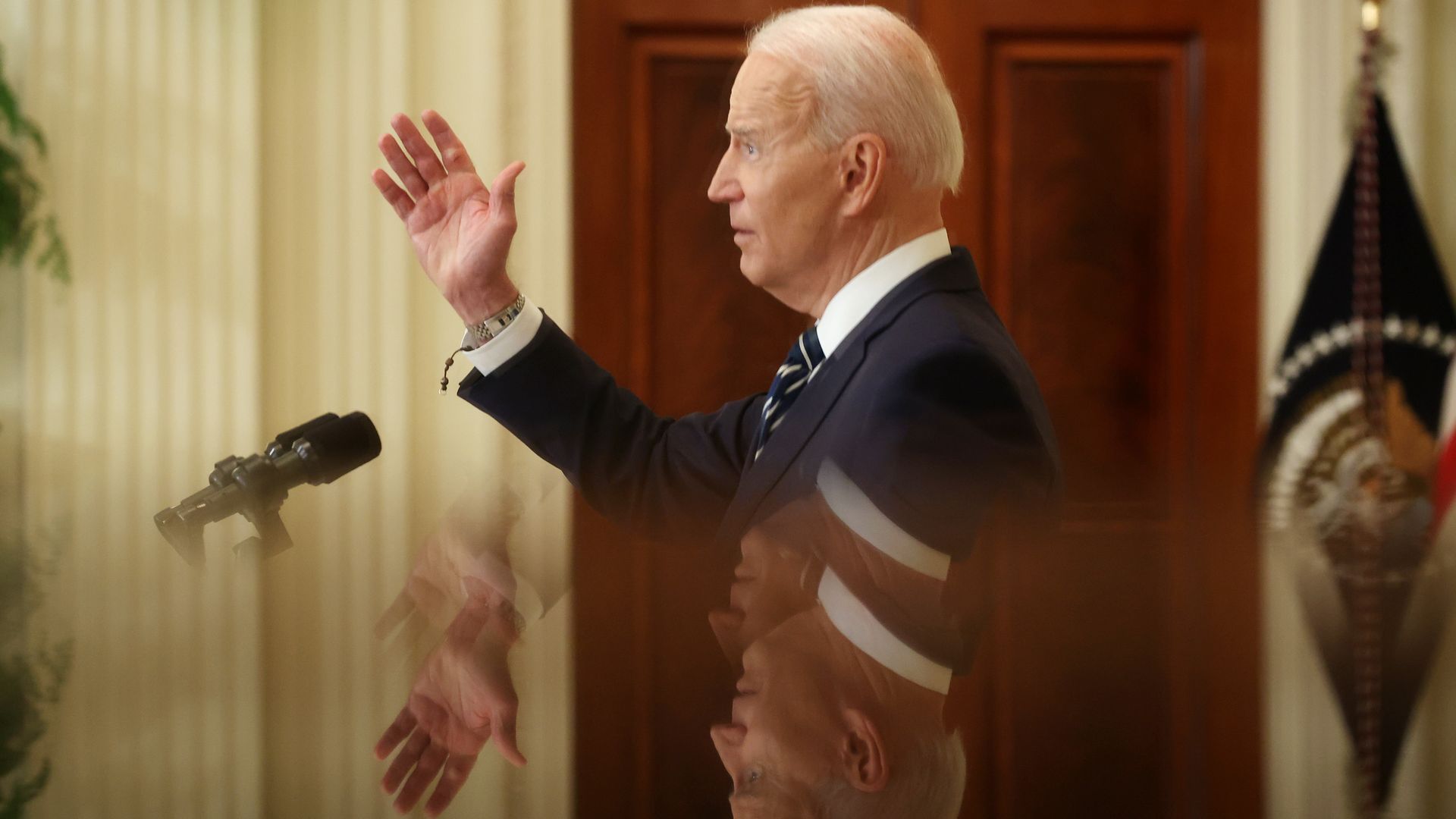 President Biden is seen in mirror image during his first White House press conference.