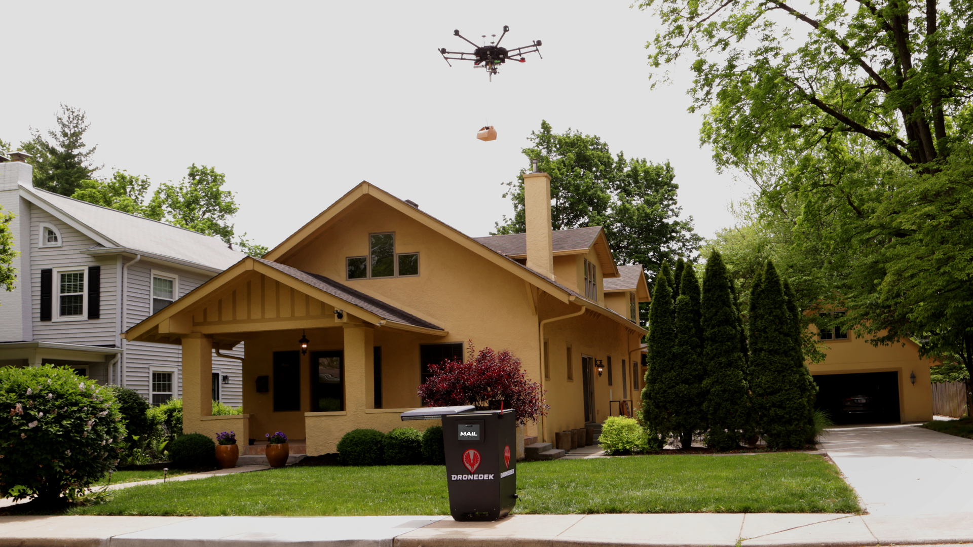 Image of a drone delivering a package to a Dronedek smart mailbox. 