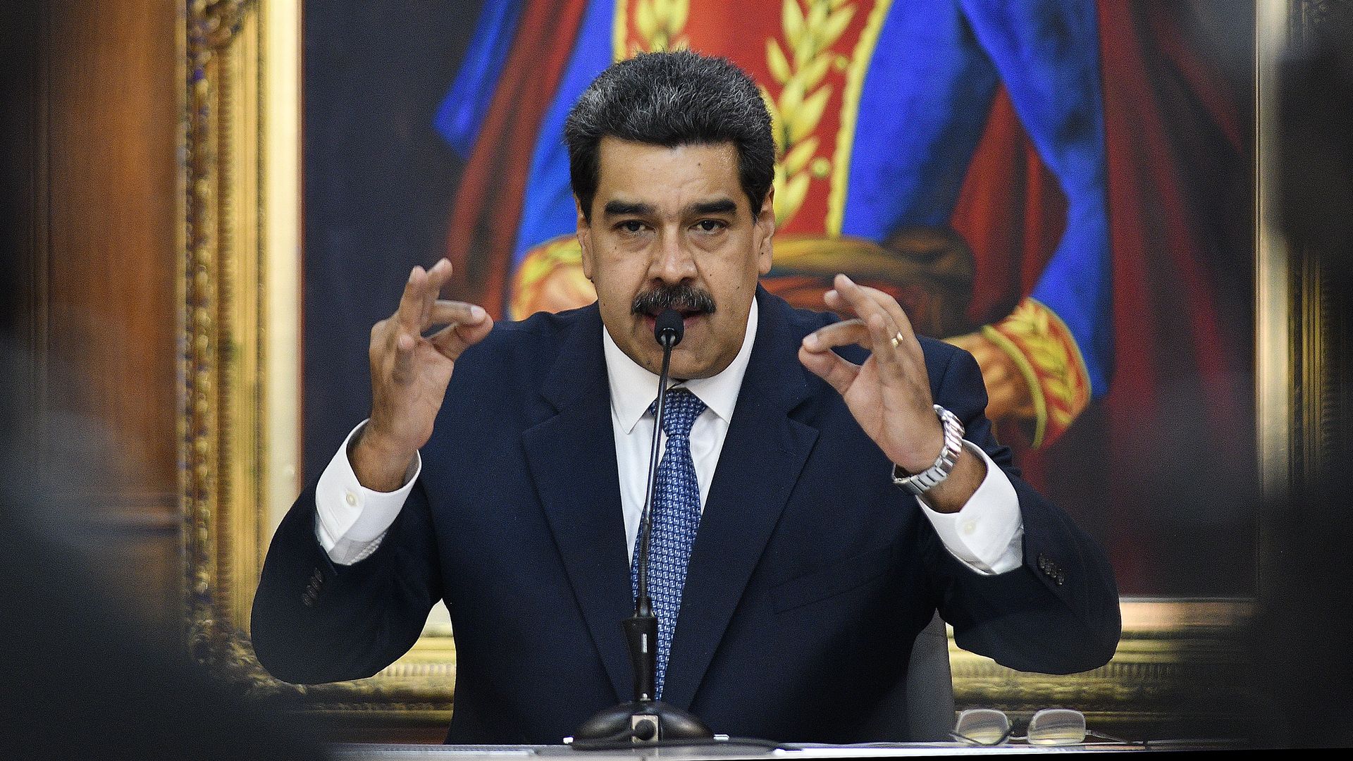 Nicolas Maduro speaking at a lectern