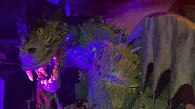 The basement of a local bookstore which is elaborately decorated with a dragon and skeletons.