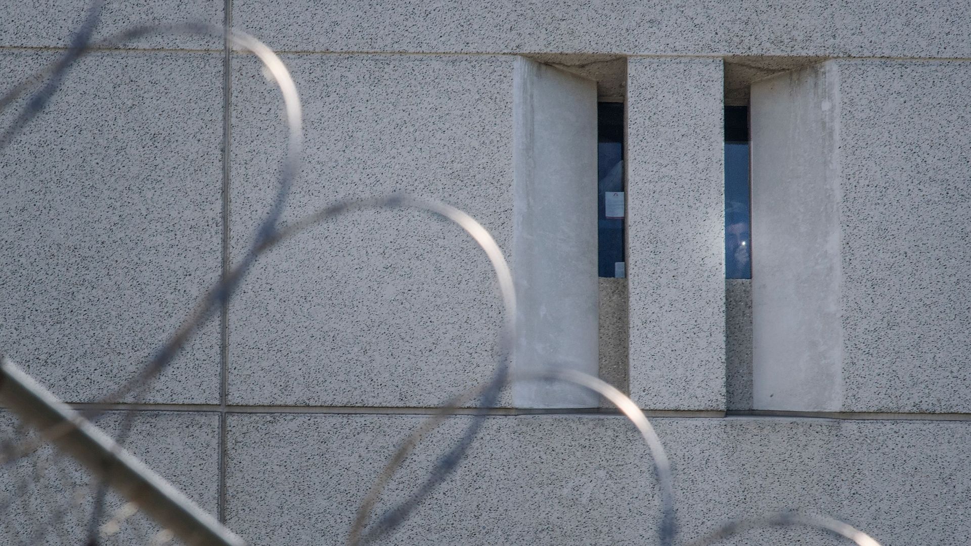 A prisoner shines a torch from the main ICE detention center in downtown Los Angeles, California