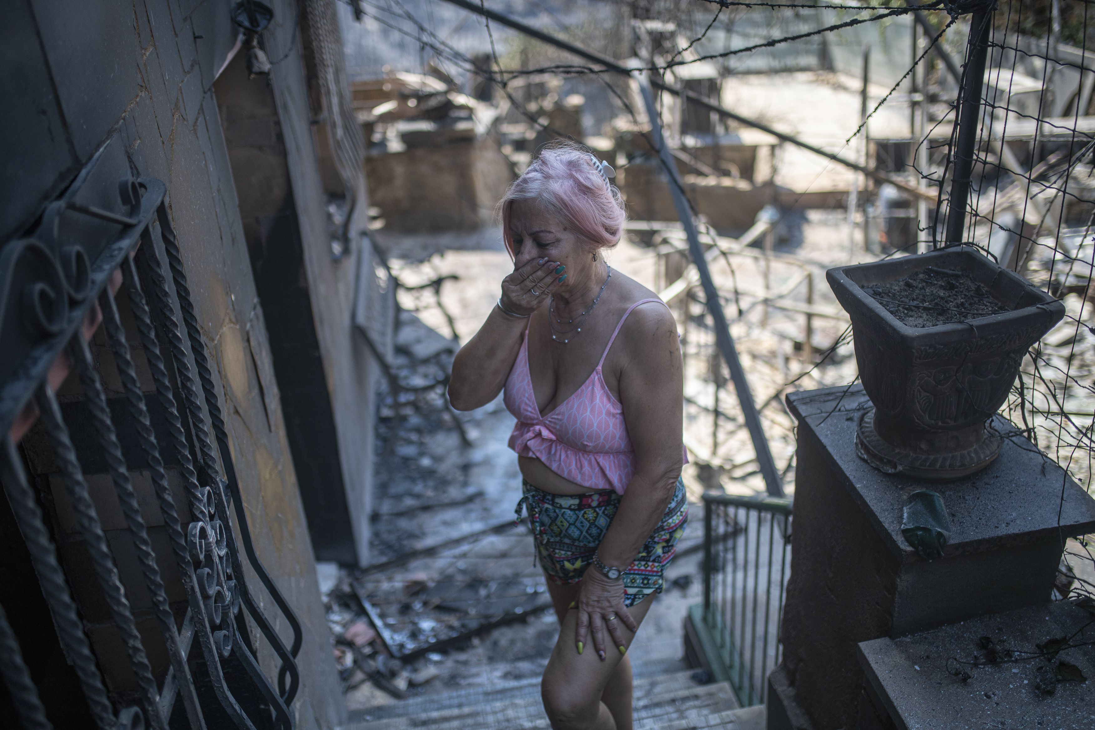 A woman cries at the state of her home affected by the fire, in the River Park urbanization, on 19 July, 2022 in Pont de Vilomara, Barcelona, Catalonia, Spain