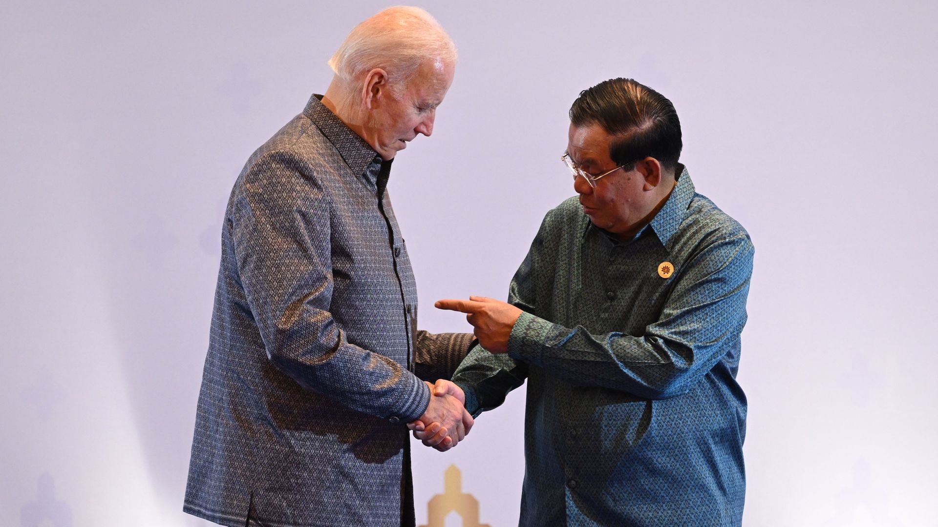 President Joe Biden (L) and Cambodia's Prime Minister Hun Sen shake hands as they attend the East Asia Summit Gala dinner in Phnom Penh, on November 12, 2022.