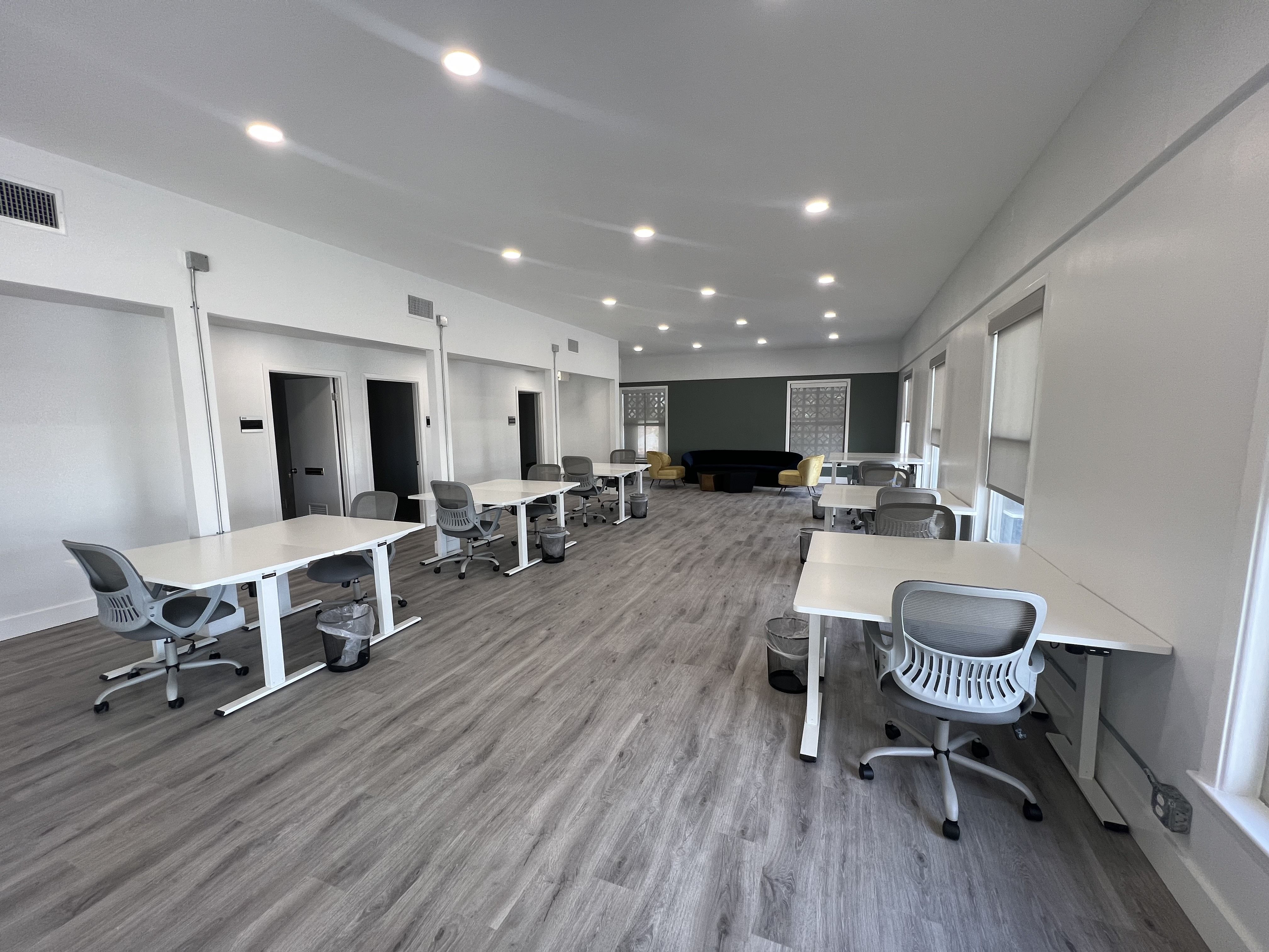 Photo shows chairs and desks in an open space.