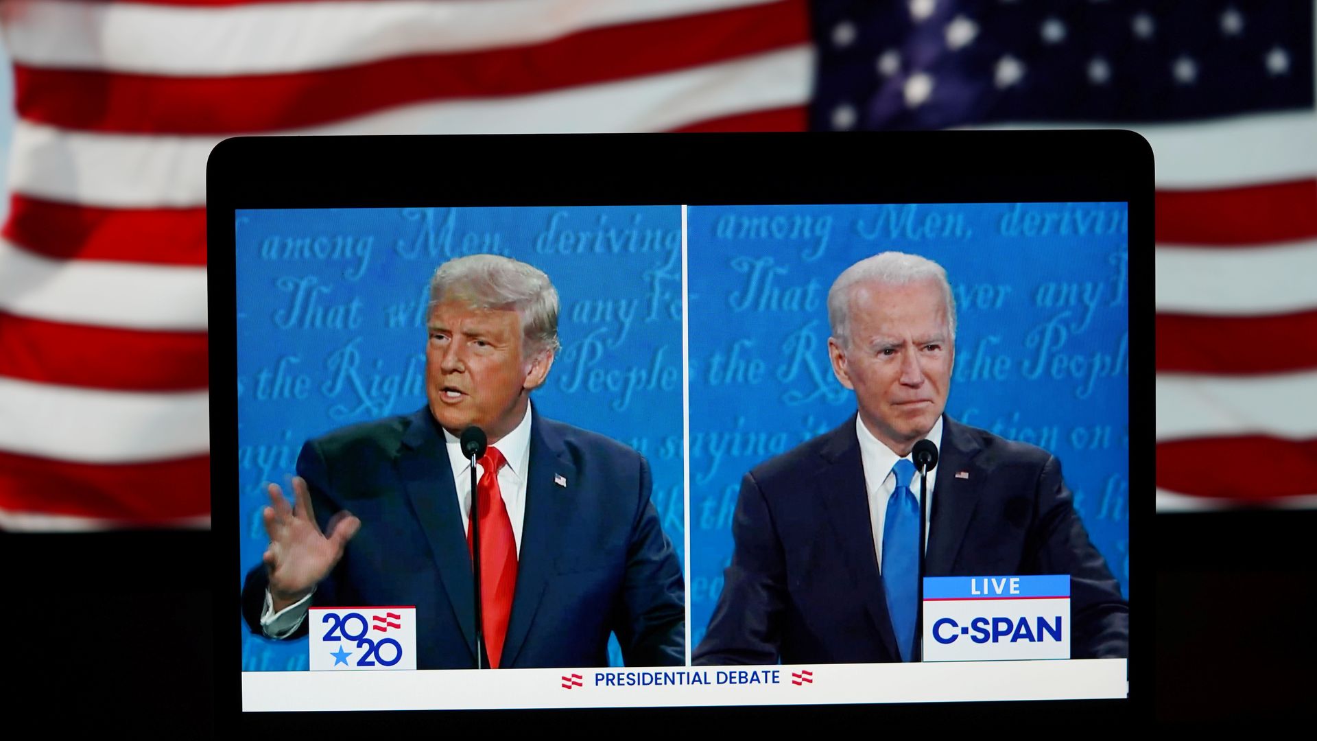 President Trump and Joe Biden on a split screen on a mobile phone during the final debate