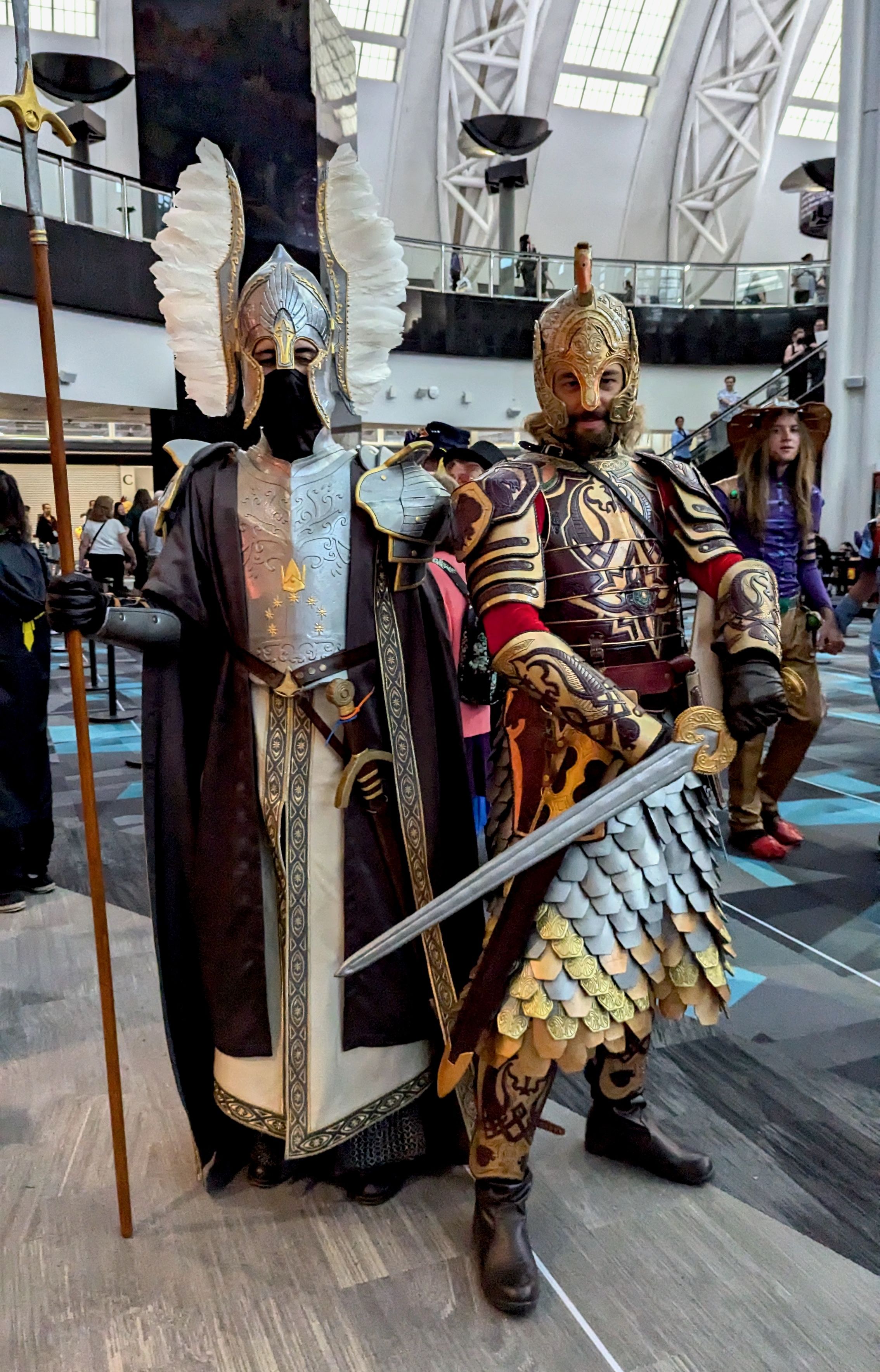 Two men costumed as a fountain guard of Gondor and a royal guard of Rohan from Lord of the Rings.