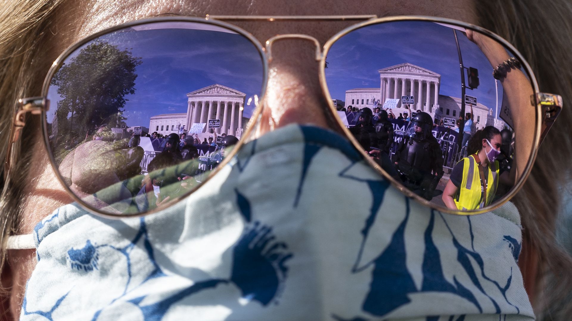 The US Supreme Court is reflected in a woman's sunglasses as protesters take part in the Women's March and Rally for Abortion Justice at the US Supreme Court.