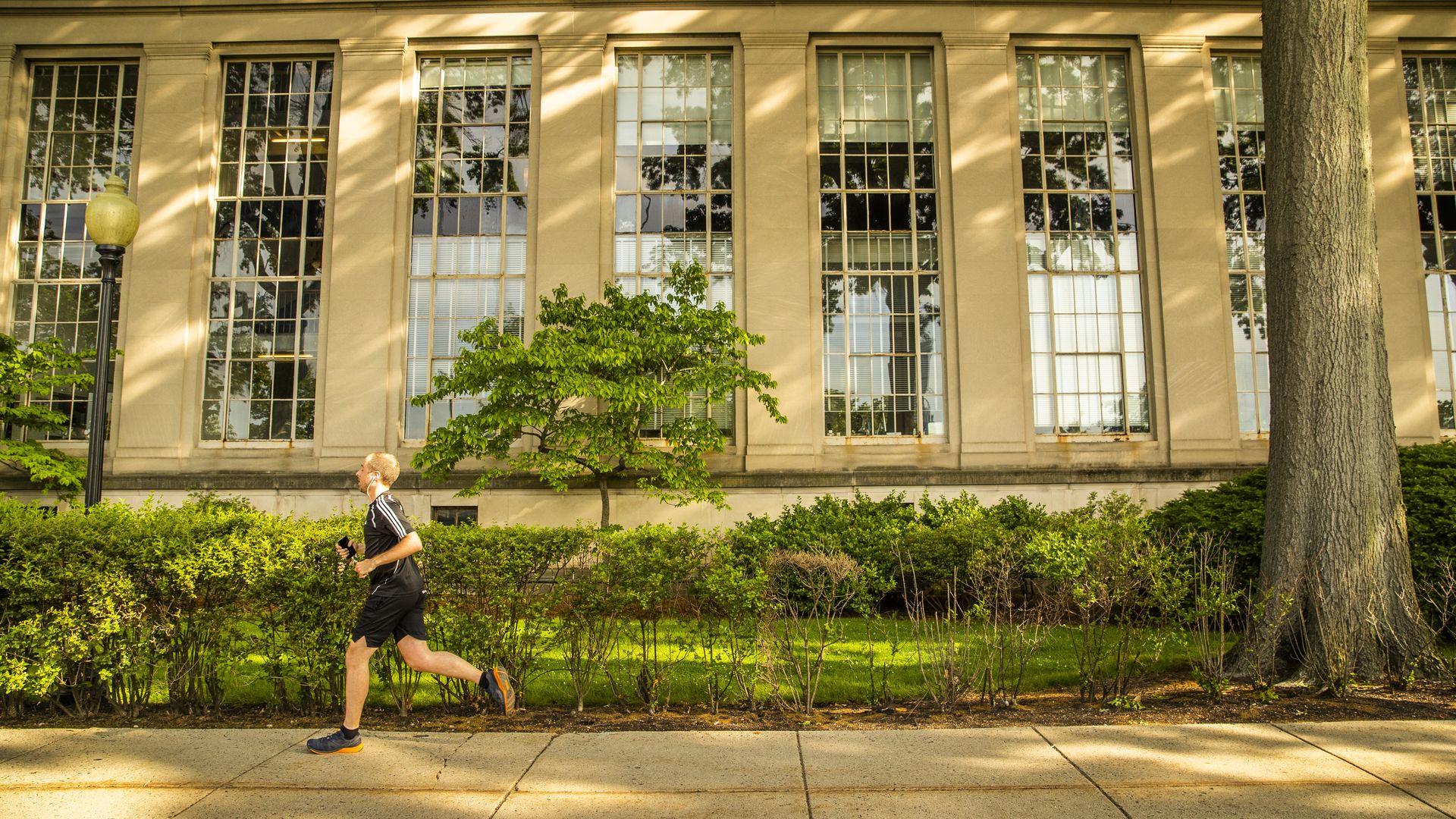 A person jogs down the street on MIT's campus in Cambridge.