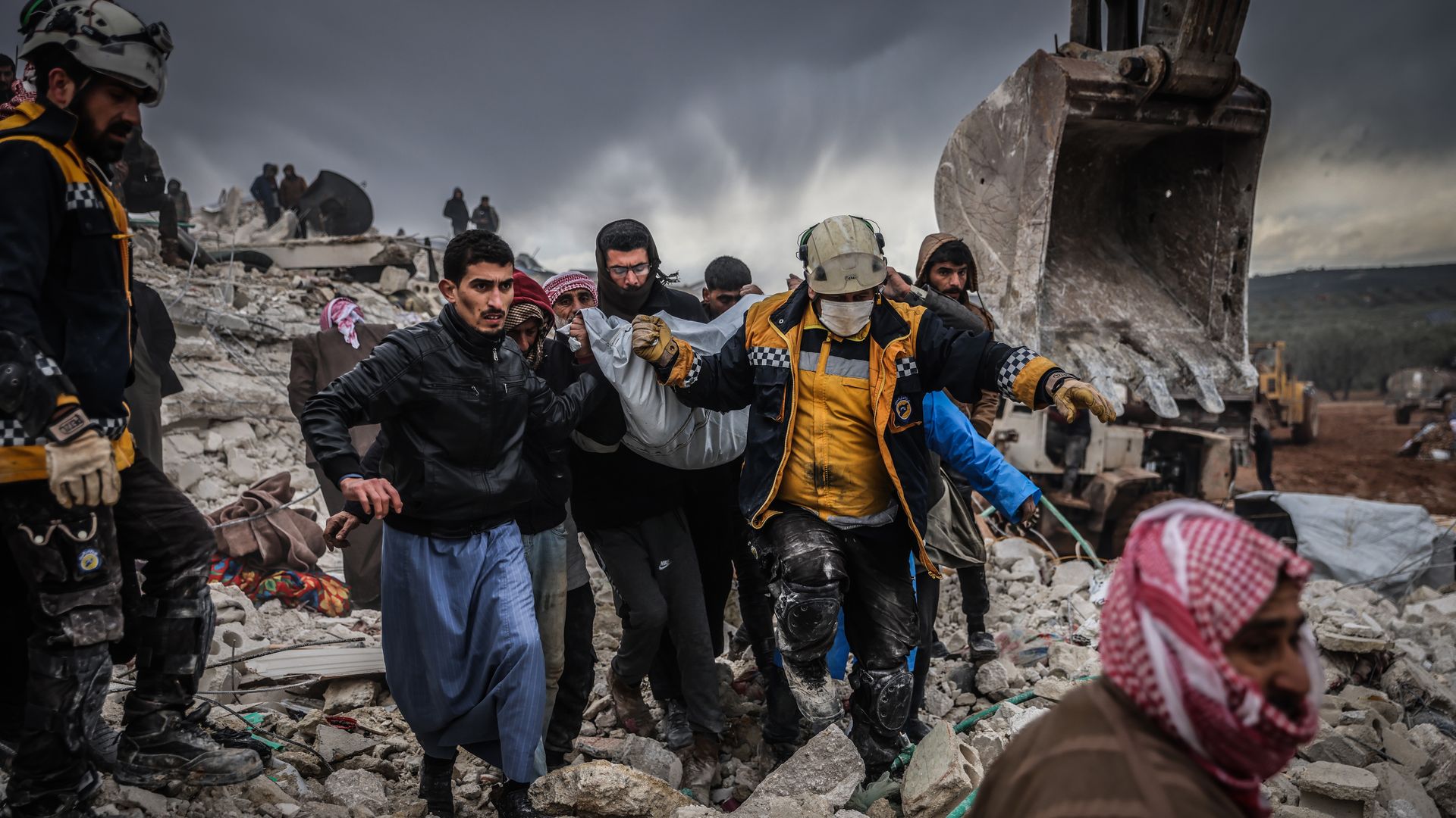 People walk through rubble after earthquake.
