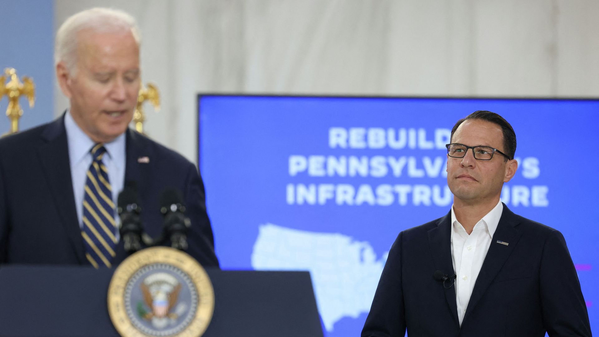 Pennsylvania Governor Josh Shapiro looks on as President Biden delivers remarks during an I-95 briefing.