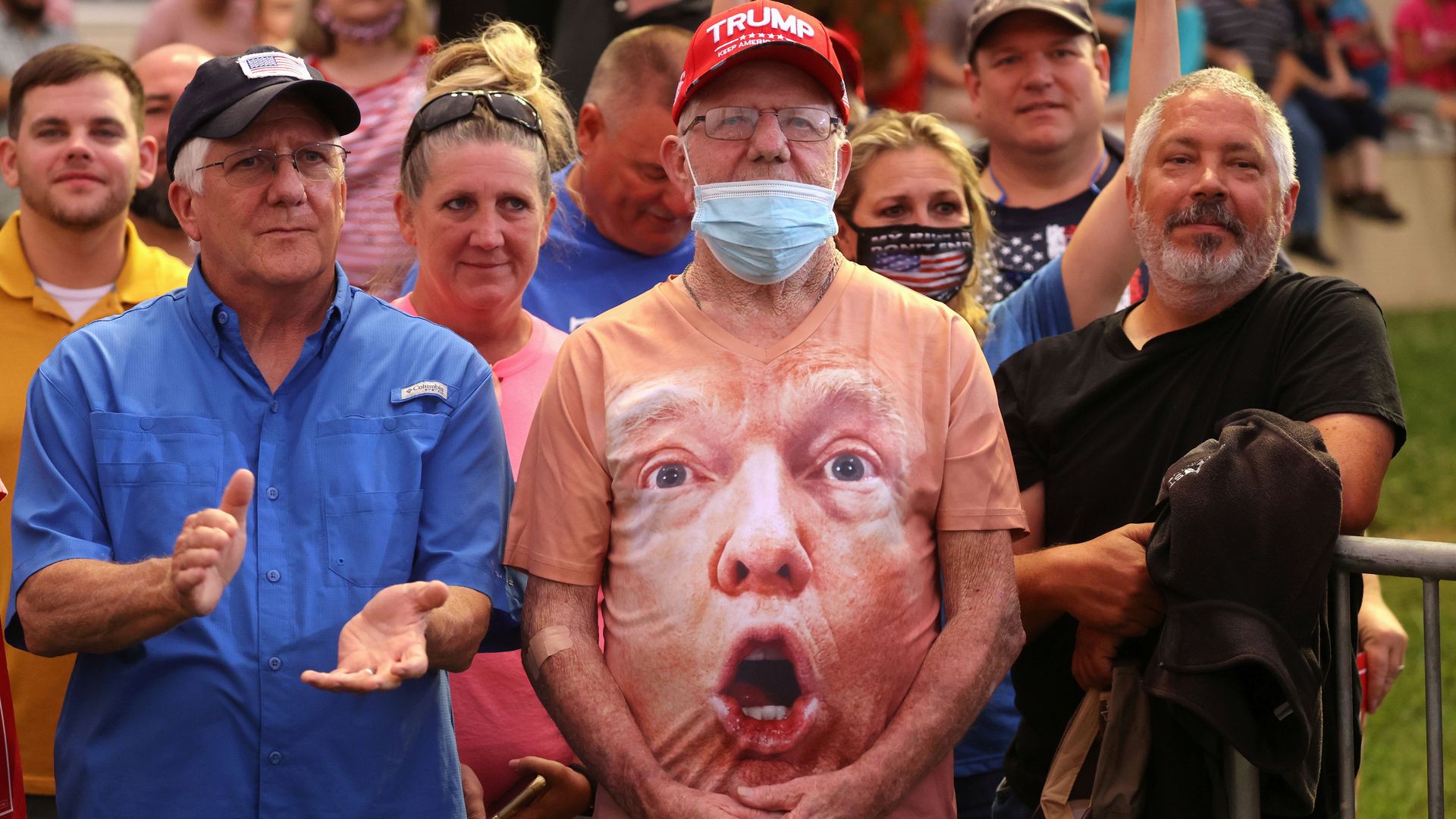 Trump supporters standing at a rally.